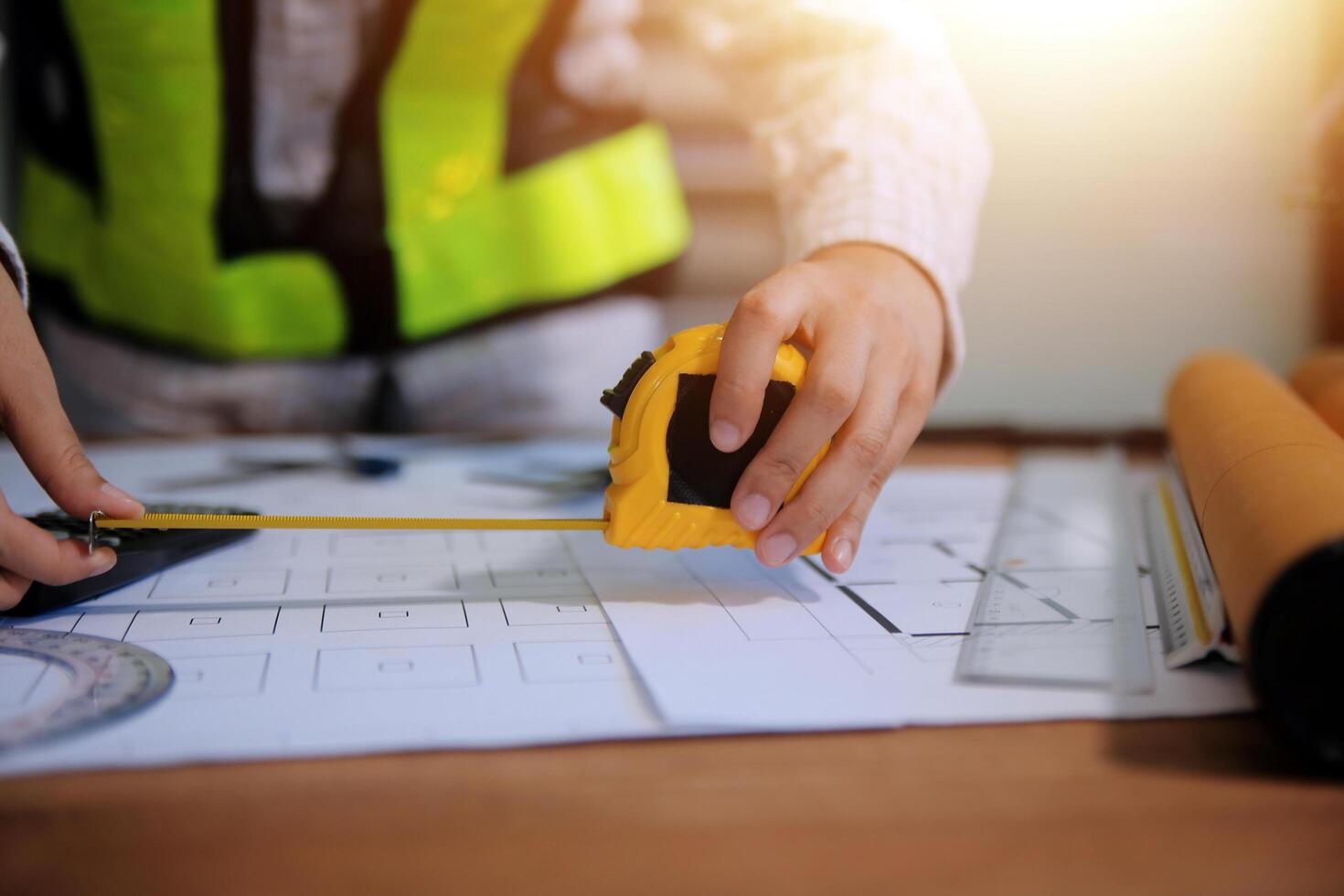 engineer people meeting working and pointing at a blueprint in office for discussing. Engineering tools and construction concept photo