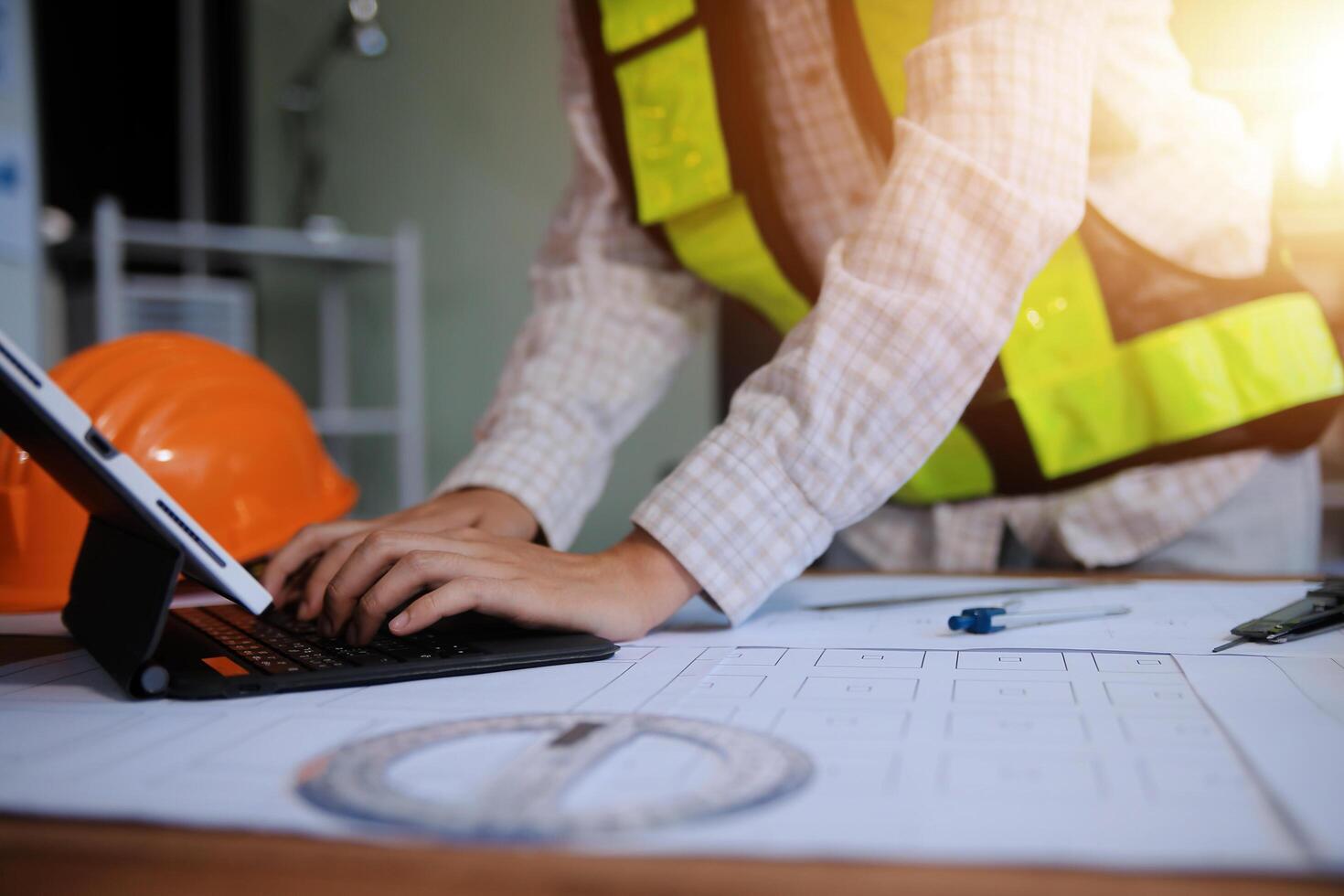 engineer people meeting working and pointing at a blueprint in office for discussing. Engineering tools and construction concept photo