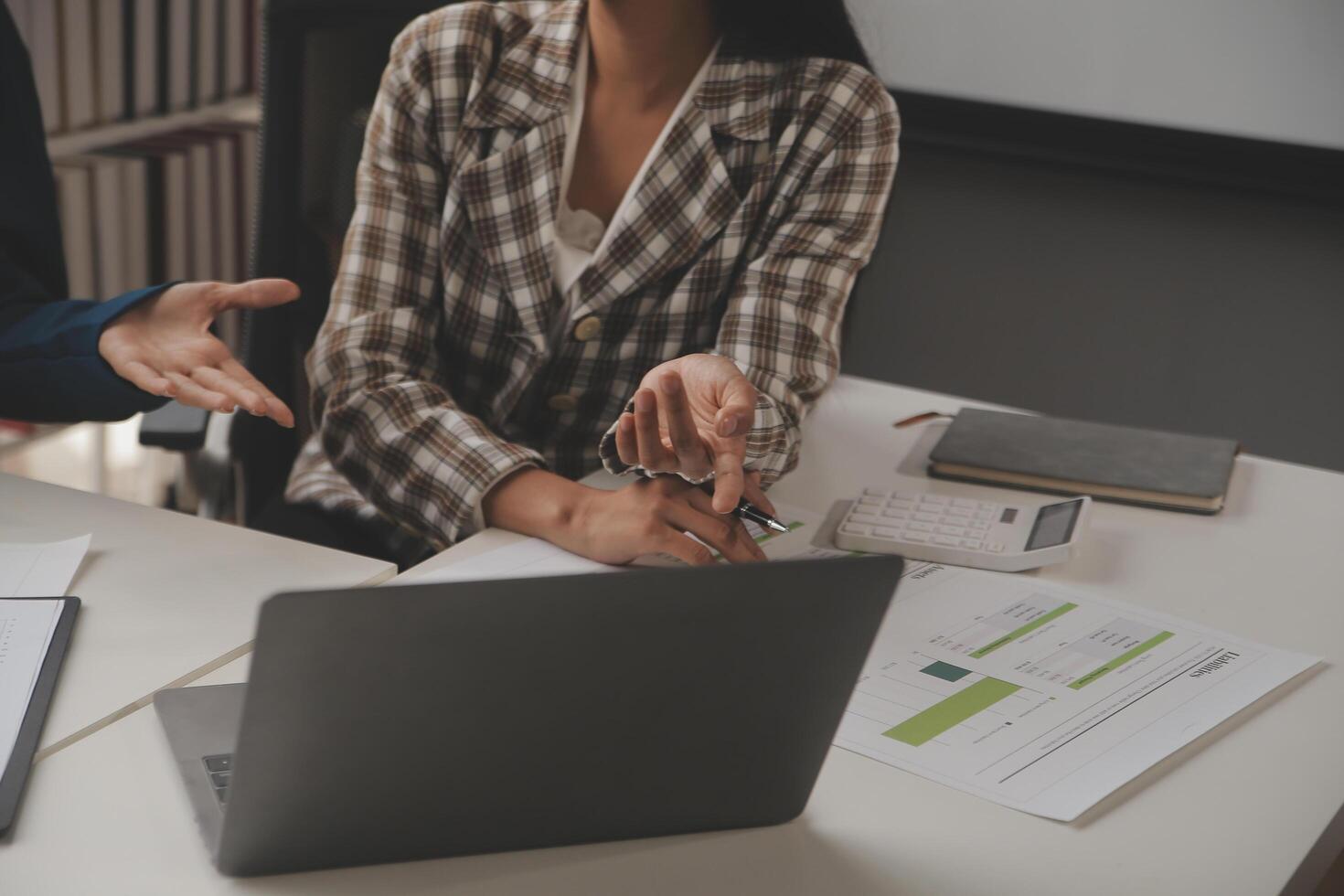 Group of confident business people point to graphs and charts to analyze market data, balance sheet, account, net profit to plan new sales strategies to increase production capacity. photo