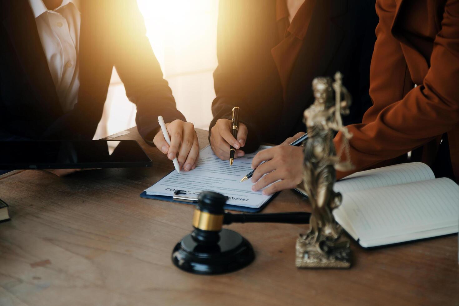 Lawyer, legal advisor, businessman brainstorming information on agreement details Business contracts in legal processing books for accuracy in contract documents. joint financial investment. photo