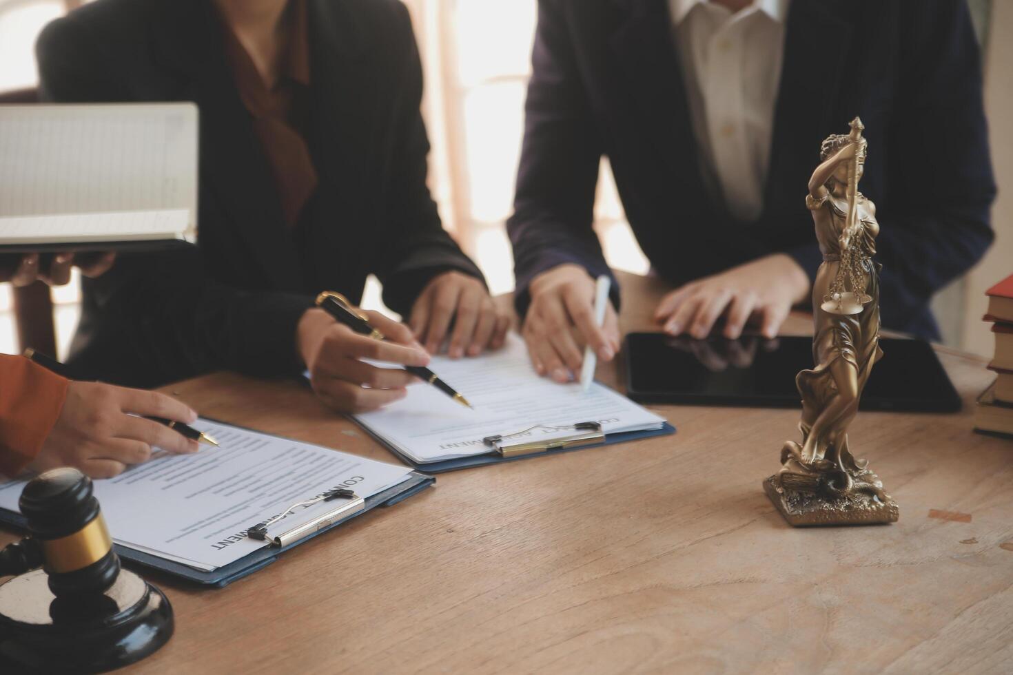 Lawyer, legal advisor, businessman brainstorming information on agreement details Business contracts in legal processing books for accuracy in contract documents. joint financial investment. photo