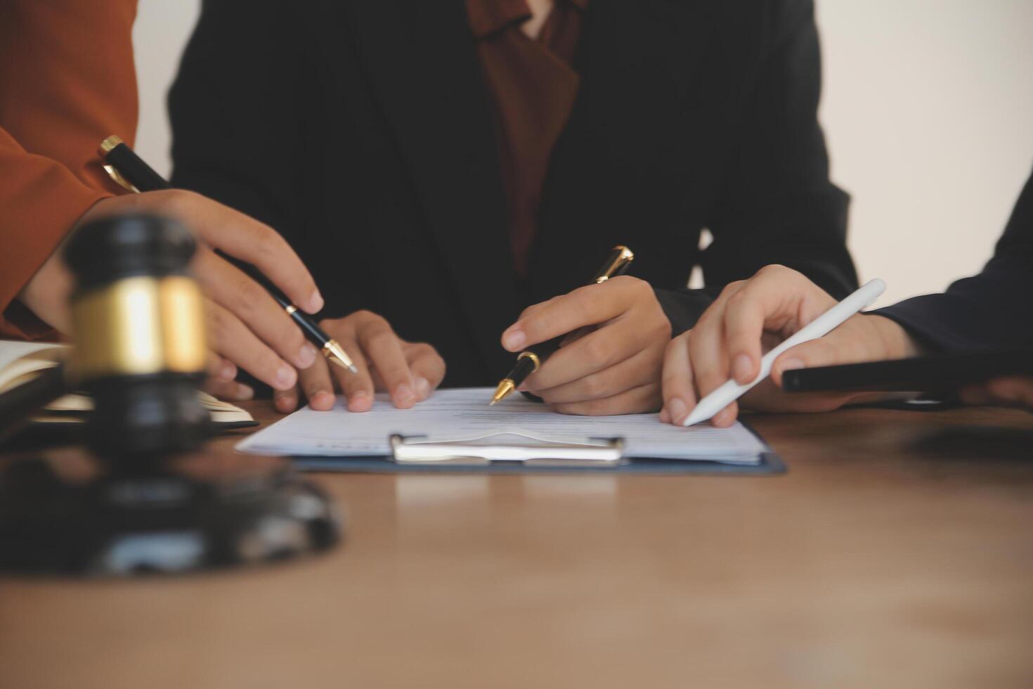 Lawyer, legal advisor, businessman brainstorming information on agreement details Business contracts in legal processing books for accuracy in contract documents. joint financial investment. photo