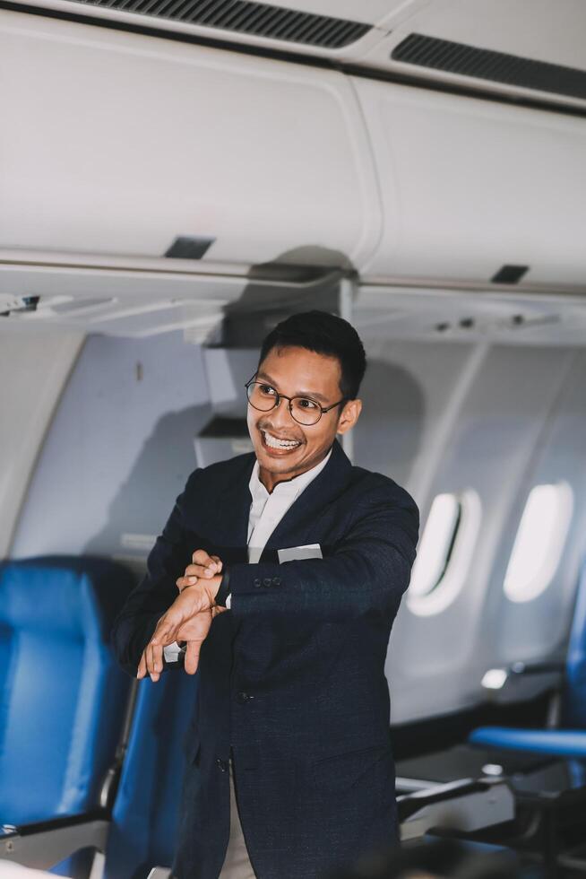 Going To Flight. Arab Businessman Walking With Suitcase In Airport And Looking At Wristwatch, Handsome Middle Eastern Male Traveller Checking Departure Time On Watch, Ready For Air Trip, Copy Space photo