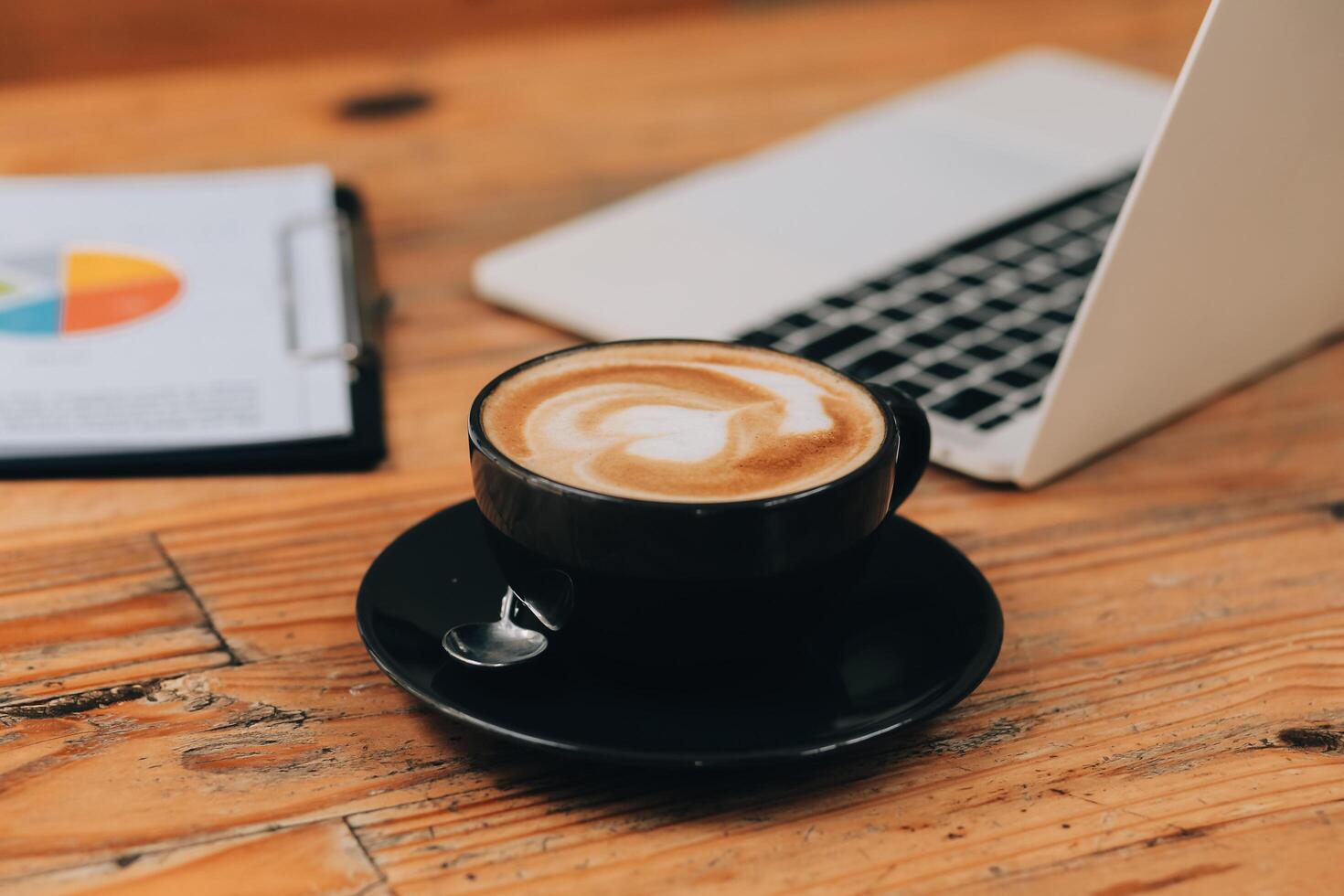 Closeup of coffee cup on table in empty corporate conference room before business meeting in office photo