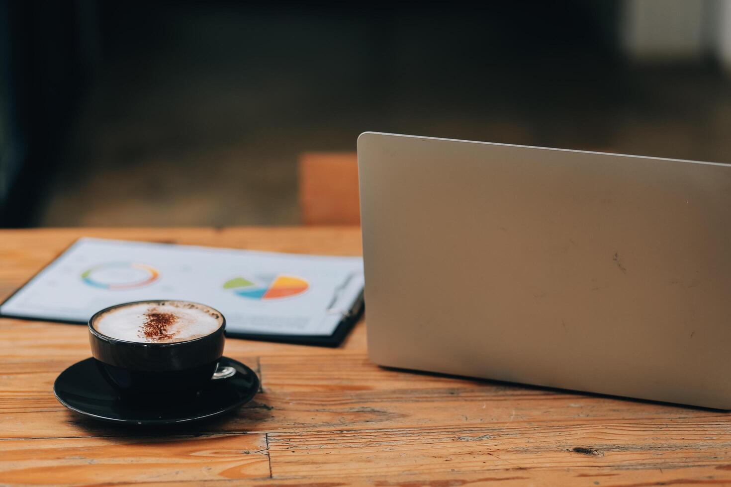 Closeup of coffee cup on table in empty corporate conference room before business meeting in office photo