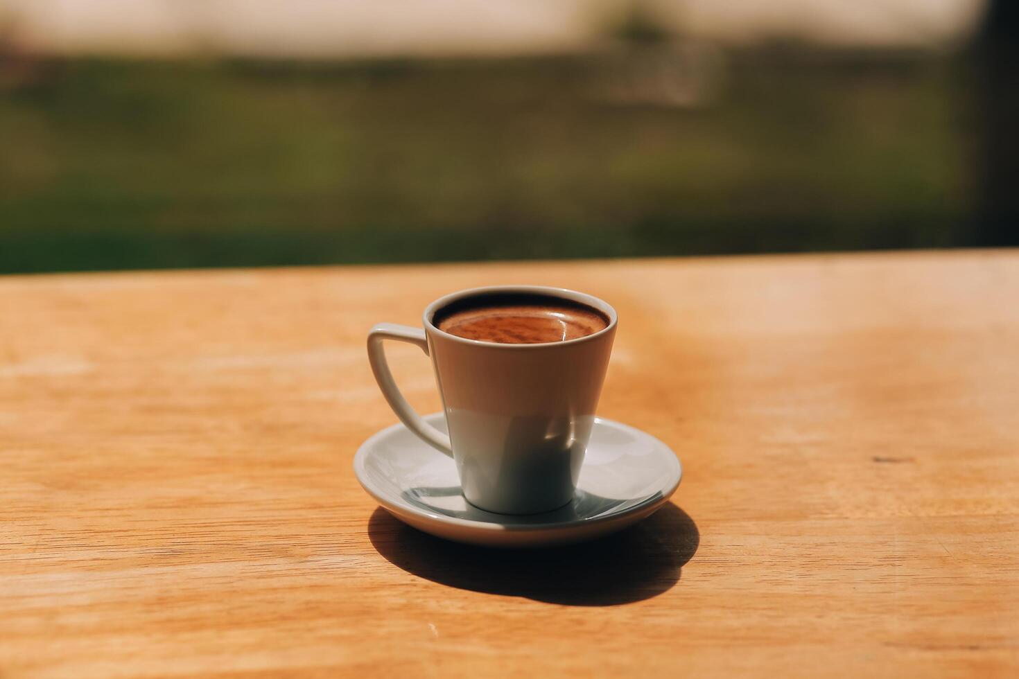 Closeup of coffee cup on table in empty corporate conference room before business meeting in office photo