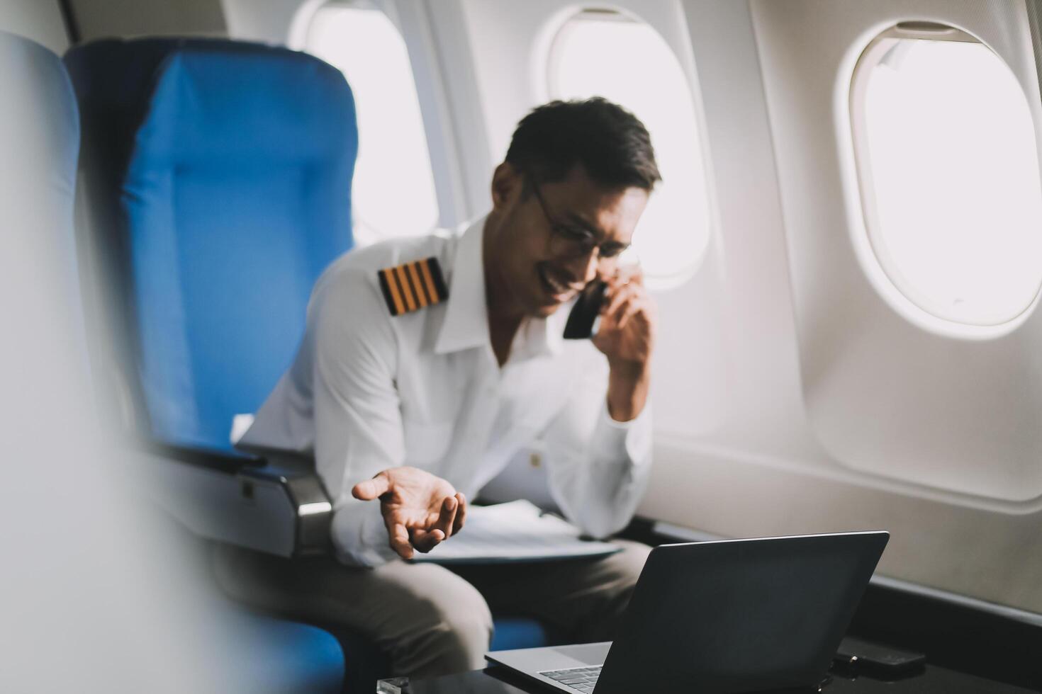 Portrait of a trained airplane captain in uniform preparing to fly in a simulator cockpit. photo