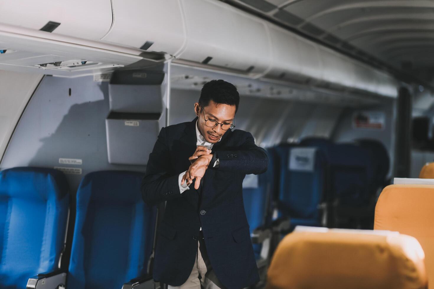 Going To Flight. Arab Businessman Walking With Suitcase In Airport And Looking At Wristwatch, Handsome Middle Eastern Male Traveller Checking Departure Time On Watch, Ready For Air Trip, Copy Space photo