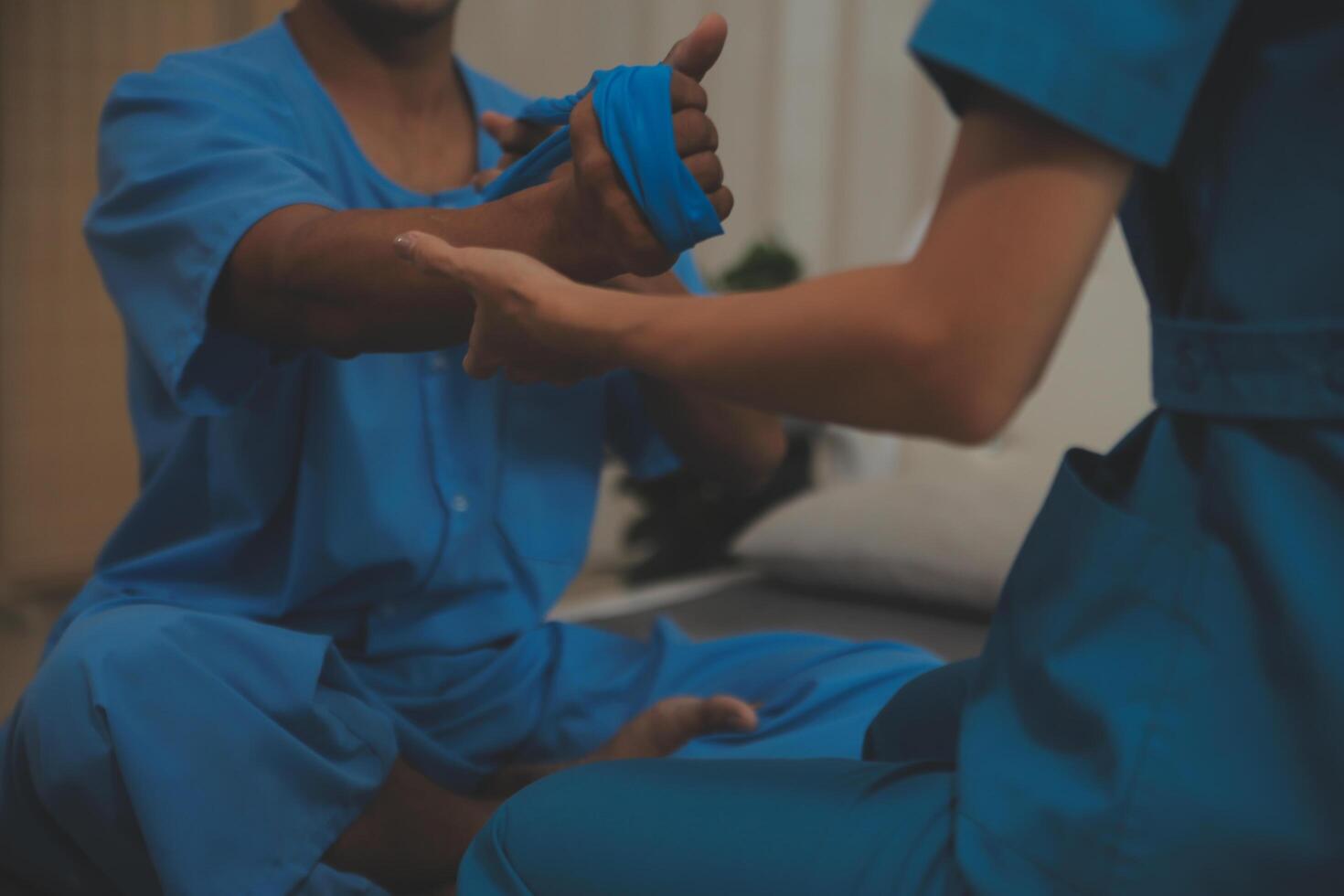 Professional physical therapist examines and cares for a young man in a physical therapy center, treating muscles and injuries of a man in a hospital. photo