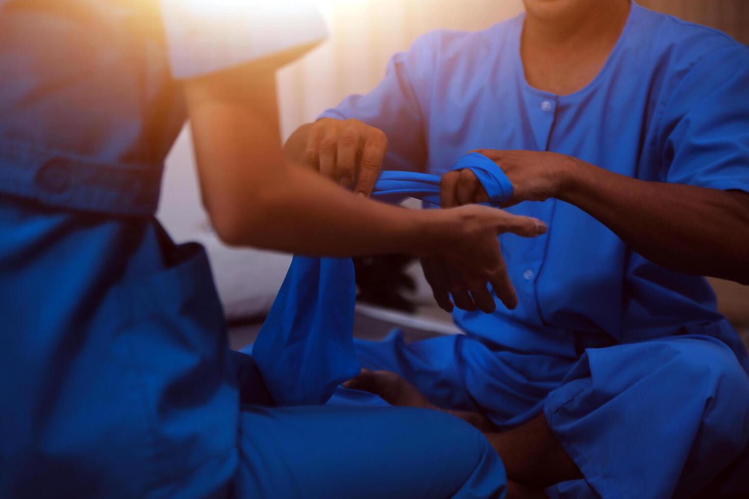 Professional physical therapist examines and cares for a young man in a physical therapy center, treating muscles and injuries of a man in a hospital. photo
