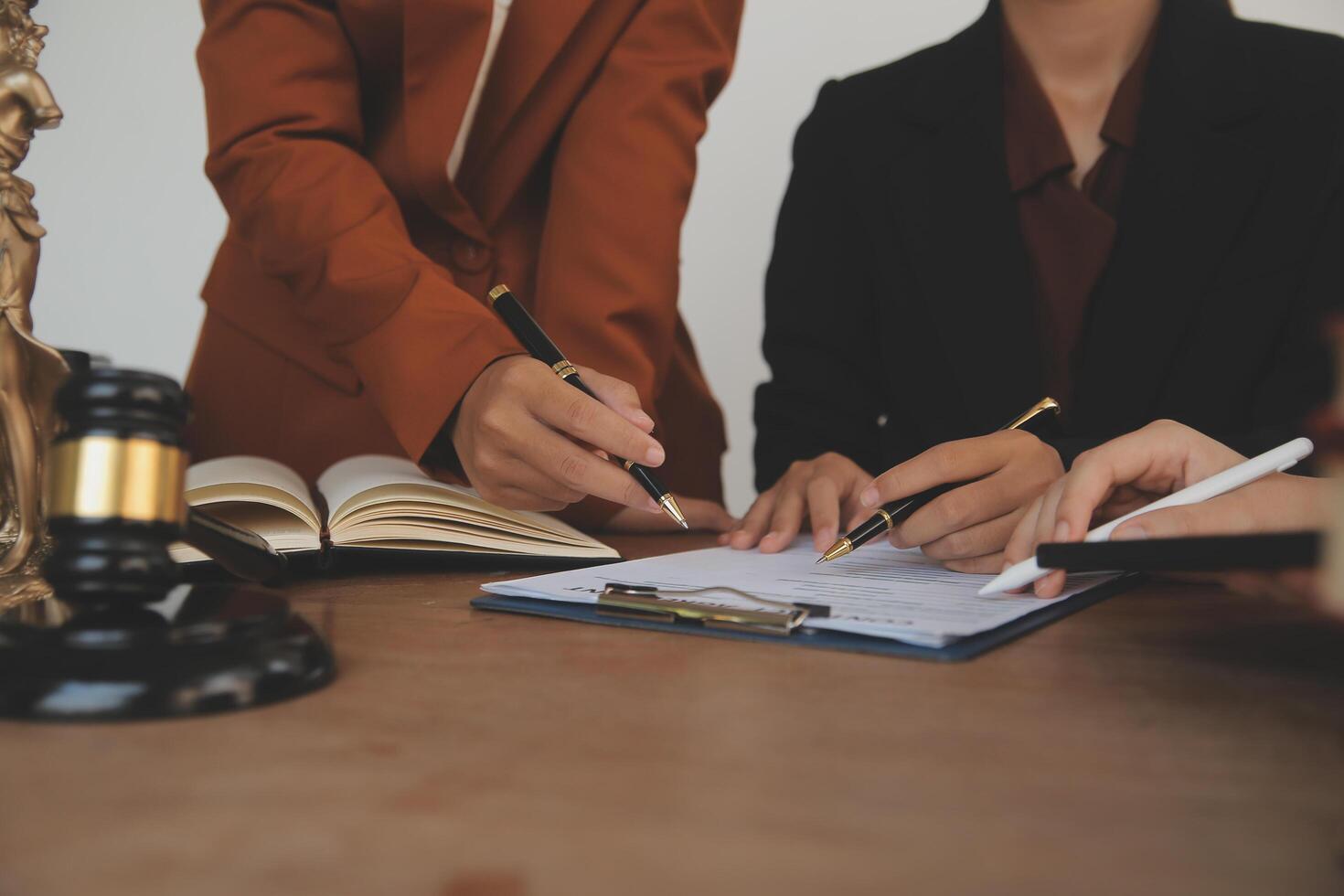 Lawyer, legal advisor, businessman brainstorming information on agreement details Business contracts in legal processing books for accuracy in contract documents. joint financial investment. photo
