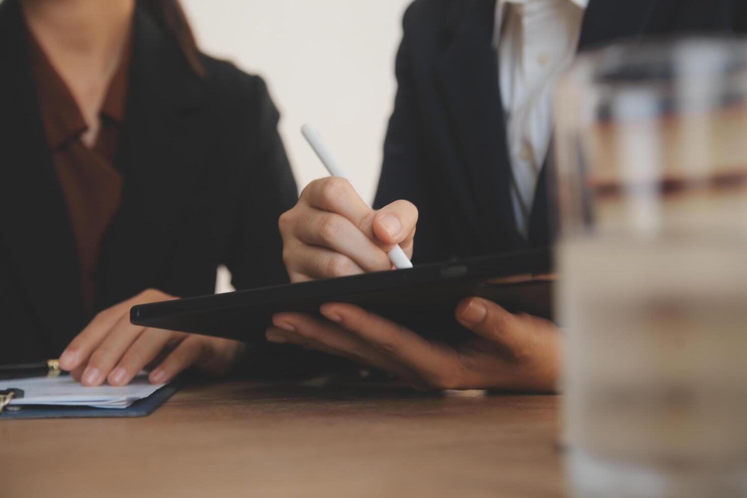 Lawyer, legal advisor, businessman brainstorming information on agreement details Business contracts in legal processing books for accuracy in contract documents. joint financial investment. photo