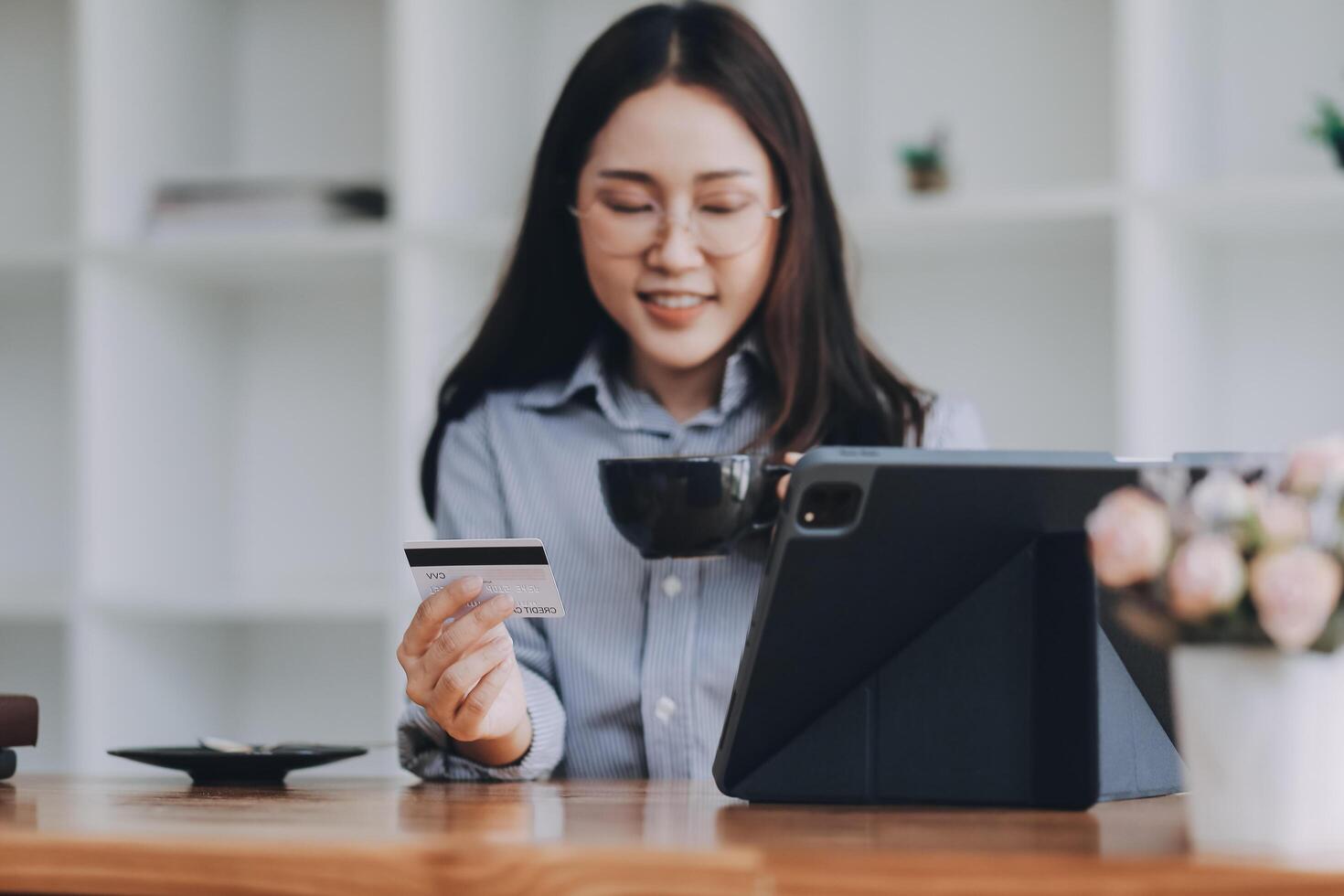 Happy asian woman using smartphone shopping online with credit card. Lifestyle. Easy pay using smart phone or digital device. photo