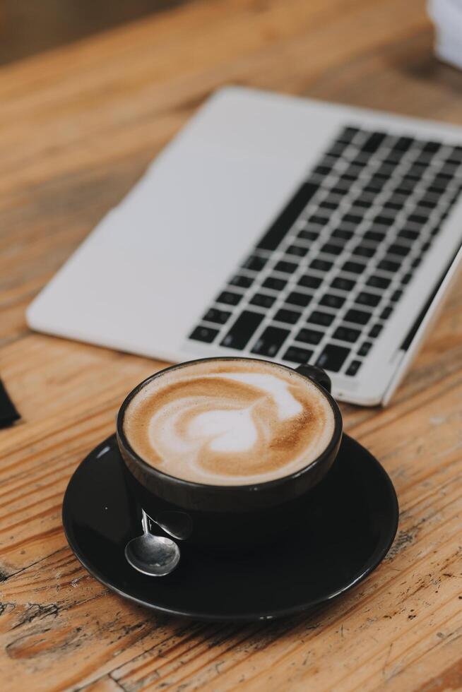 Closeup of coffee cup on table in empty corporate conference room before business meeting in office photo