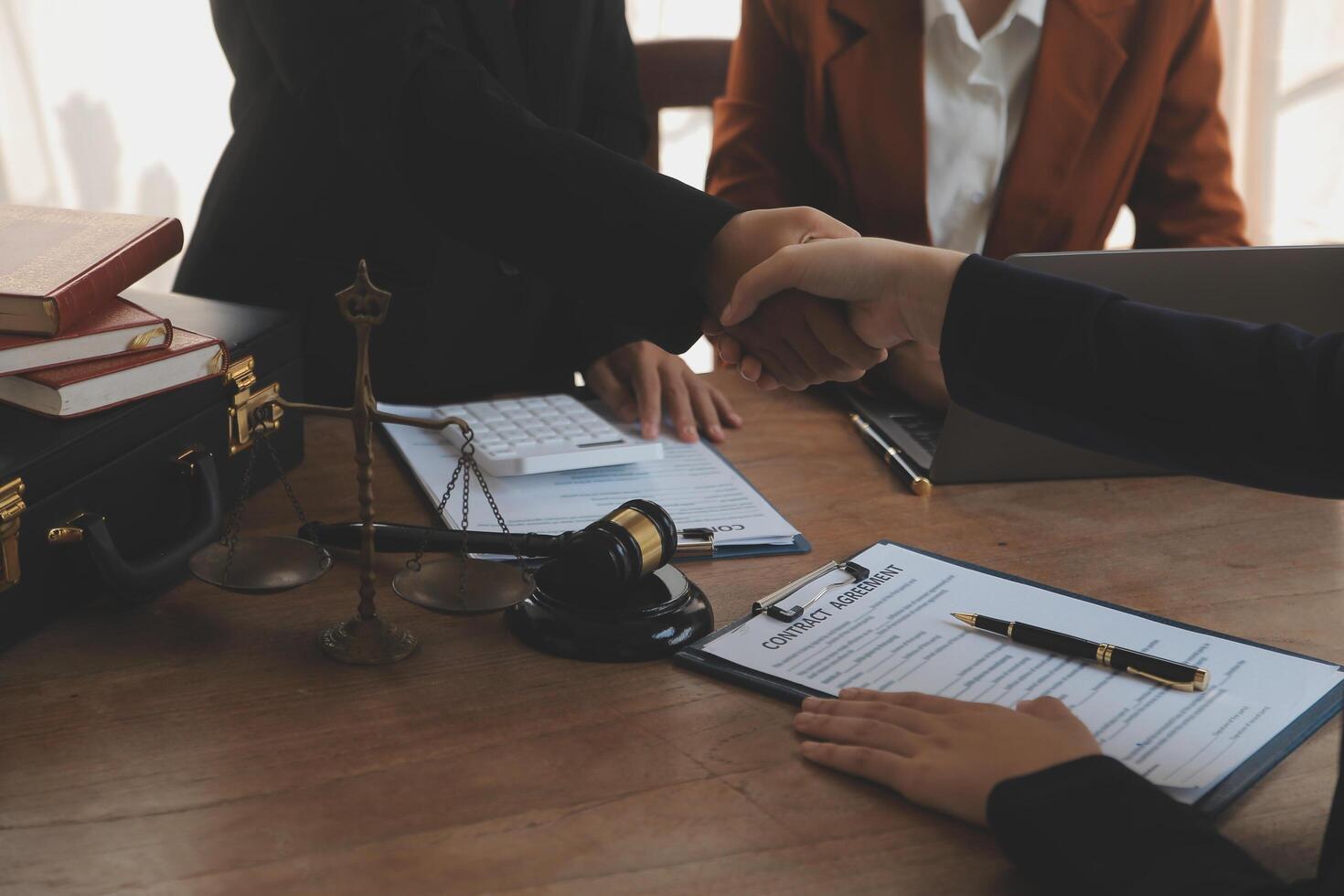 concept of justice and law A male judge in the courtroom on a wooden table and a male counselor or lawyer working in the office. Law, advice and justice concepts. photo