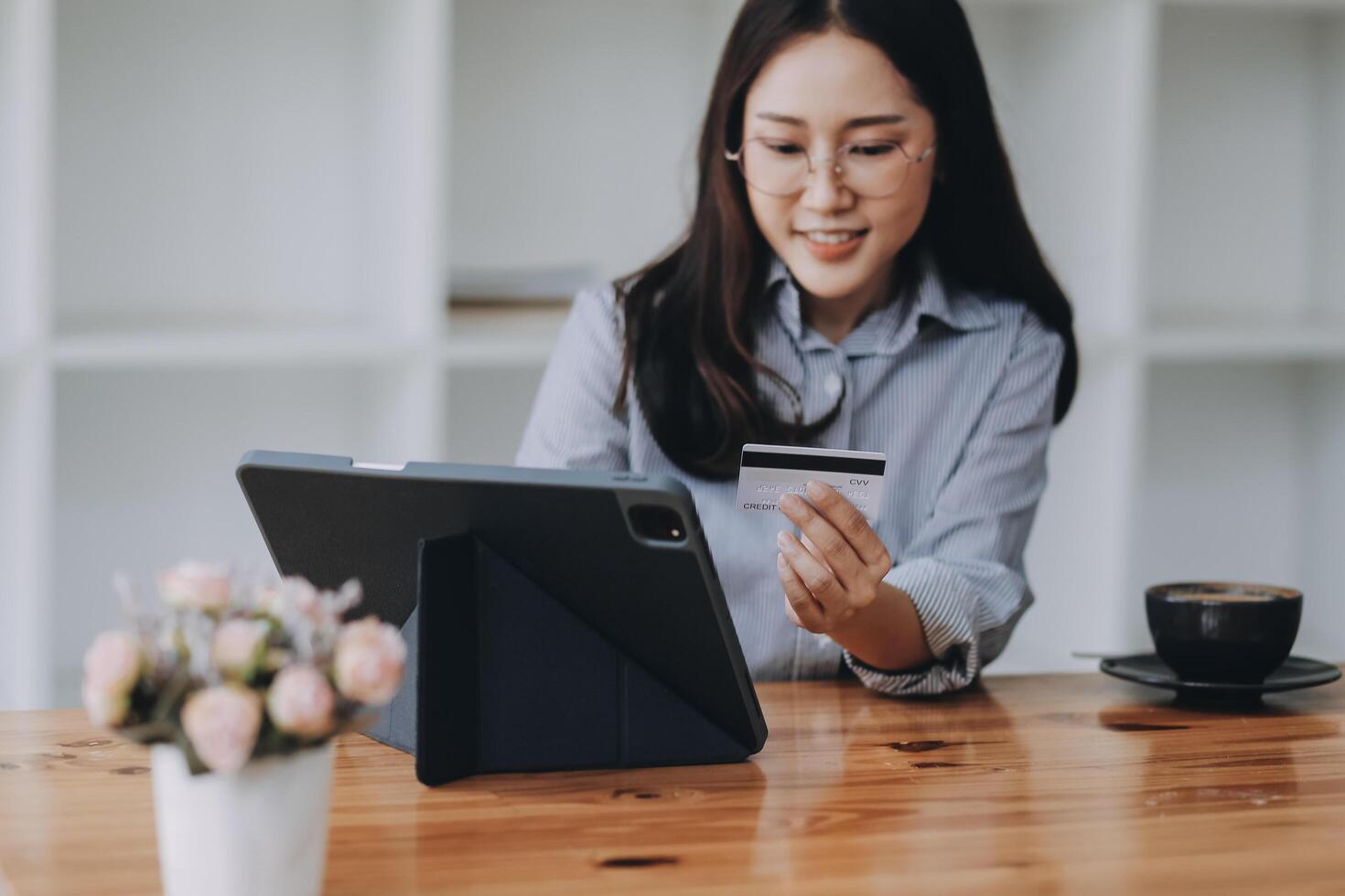 Happy asian woman using smartphone shopping online with credit card. Lifestyle. Easy pay using smart phone or digital device. photo