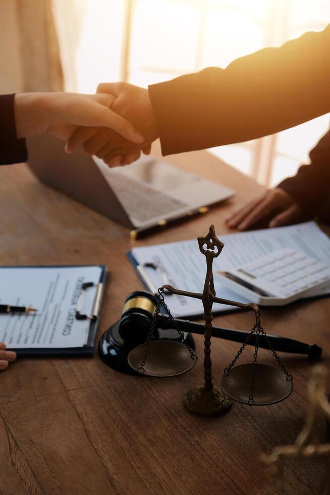 concept of justice and law A male judge in the courtroom on a wooden table and a male counselor or lawyer working in the office. Law, advice and justice concepts. photo