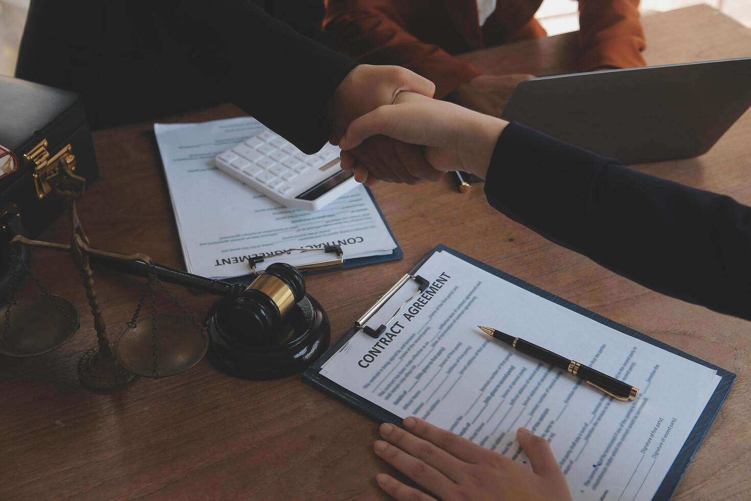 concept of justice and law A male judge in the courtroom on a wooden table and a male counselor or lawyer working in the office. Law, advice and justice concepts. photo