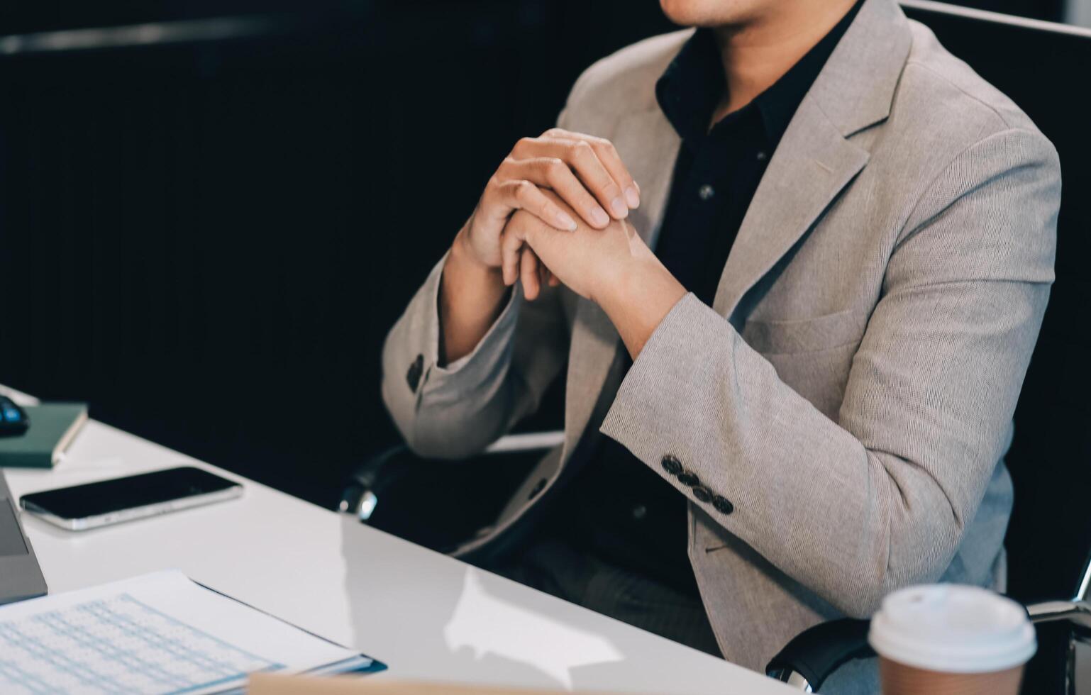 call online meeting asian businessman looking web camera and having fun talking and gesturing, man working inside office sharing plans with partners and colleagues, boss in shirt and glasses. photo