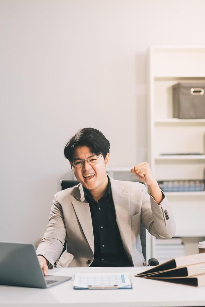 call online meeting asian businessman looking web camera and having fun talking and gesturing, man working inside office sharing plans with partners and colleagues, boss in shirt and glasses. photo