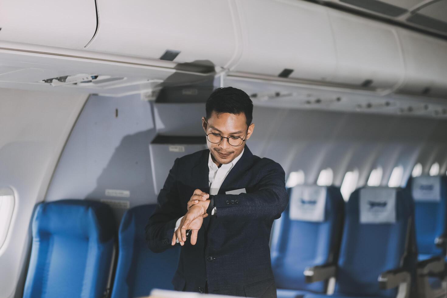 Going To Flight. Arab Businessman Walking With Suitcase In Airport And Looking At Wristwatch, Handsome Middle Eastern Male Traveller Checking Departure Time On Watch, Ready For Air Trip, Copy Space photo