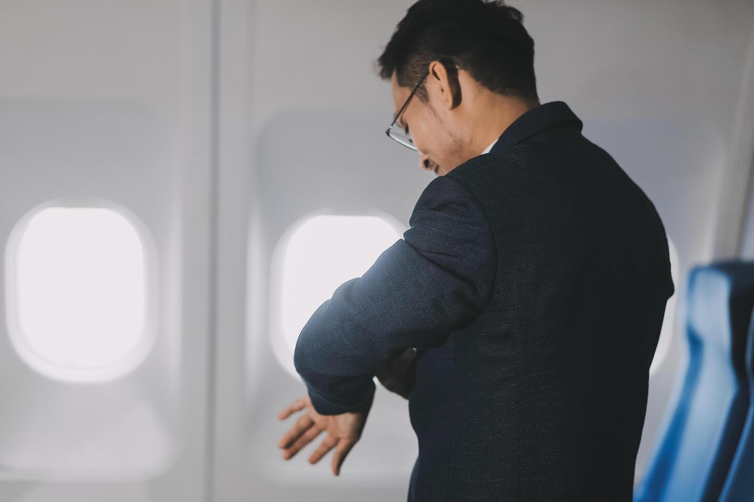 Going To Flight. Arab Businessman Walking With Suitcase In Airport And Looking At Wristwatch, Handsome Middle Eastern Male Traveller Checking Departure Time On Watch, Ready For Air Trip, Copy Space photo