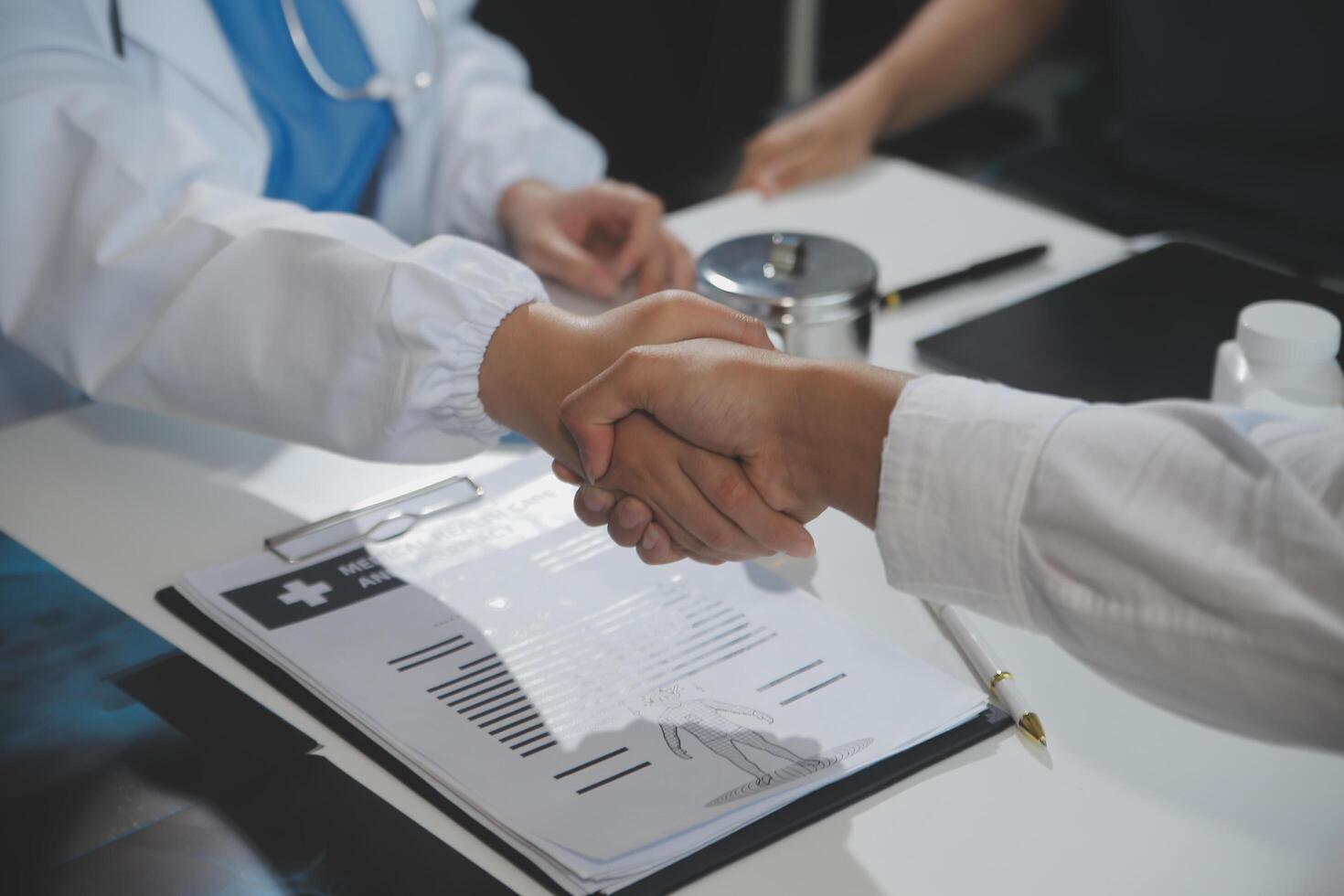 Doctor handshake and partnership in healthcare, medicine or trust for collaboration, unity or support.Team of medical experts shaking hands in teamwork for or success in hospital photo