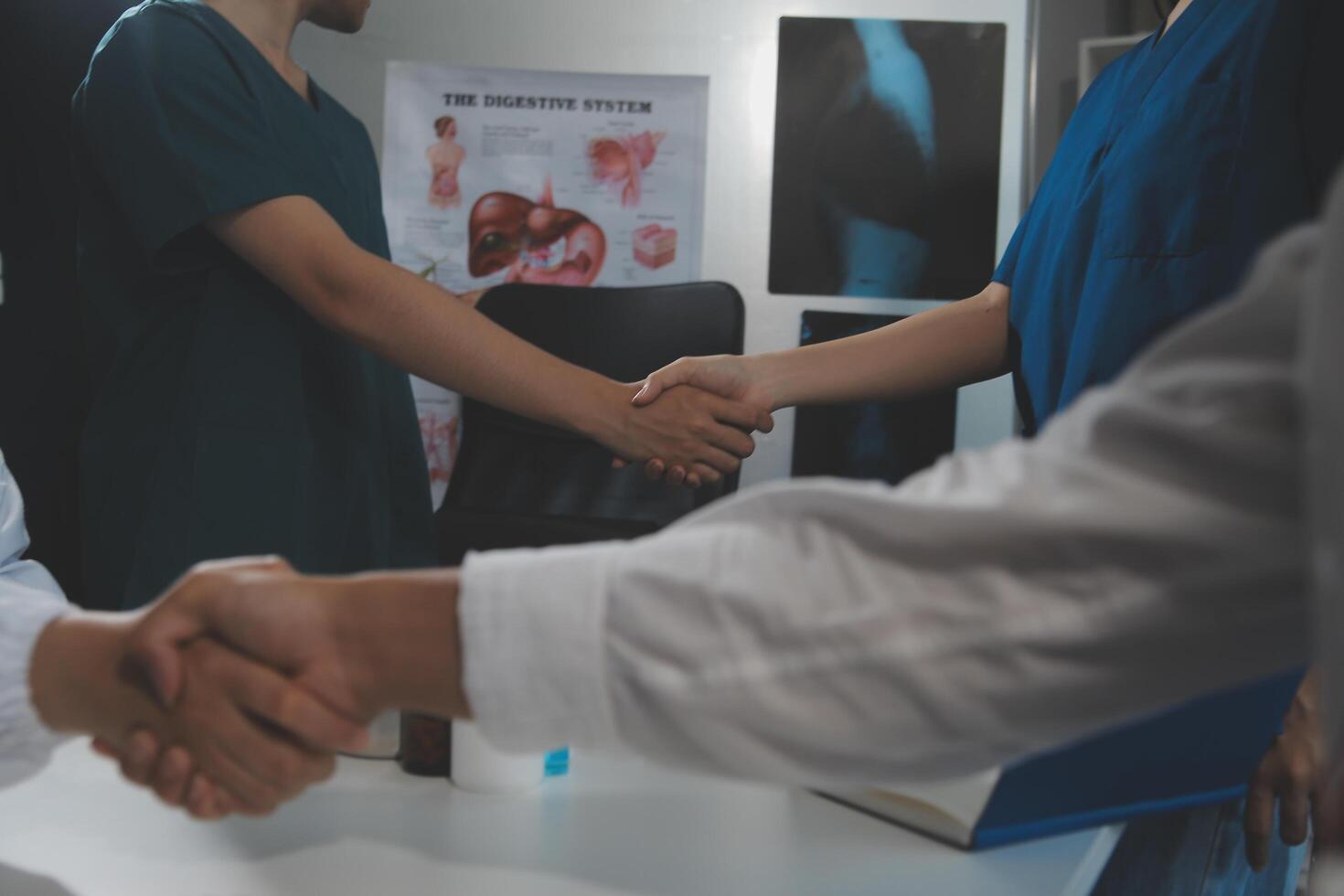Doctor handshake and partnership in healthcare, medicine or trust for collaboration, unity or support.Team of medical experts shaking hands in teamwork for or success in hospital photo