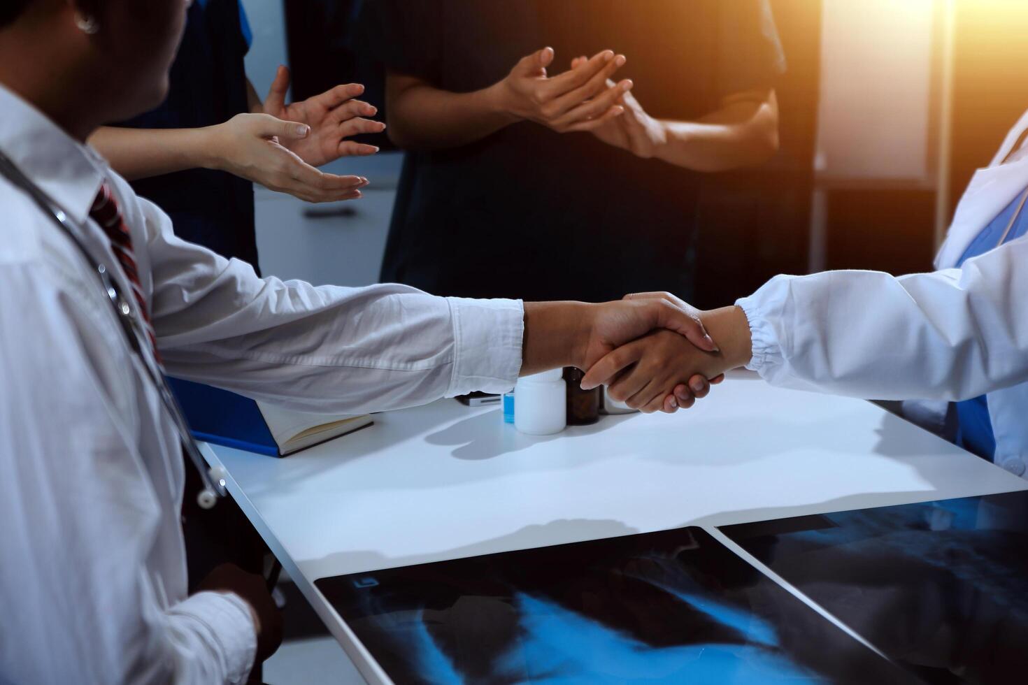 Doctor handshake and partnership in healthcare, medicine or trust for collaboration, unity or support.Team of medical experts shaking hands in teamwork for or success in hospital photo