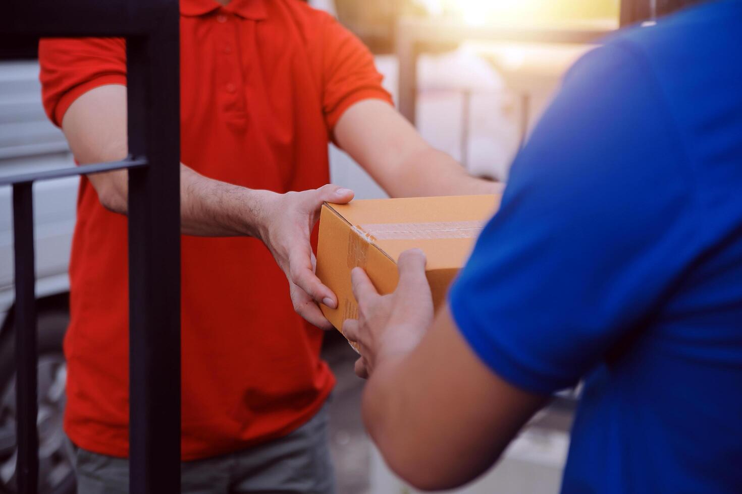 Asian delivery express courier young man use giving boxes to woman customer he wearing protective face mask at front home photo