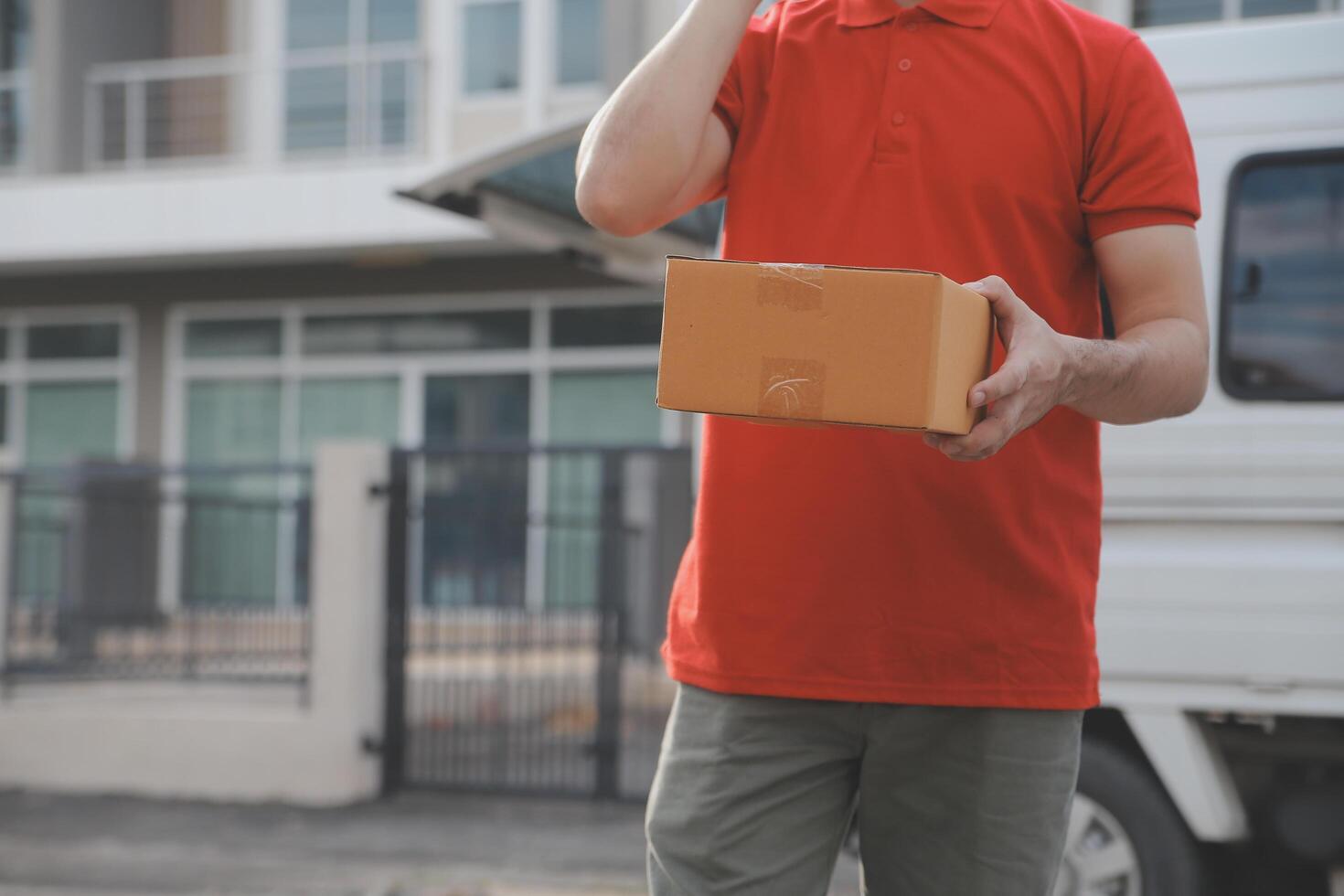 Asian delivery express courier young man use giving boxes to woman customer he wearing protective face mask at front home photo