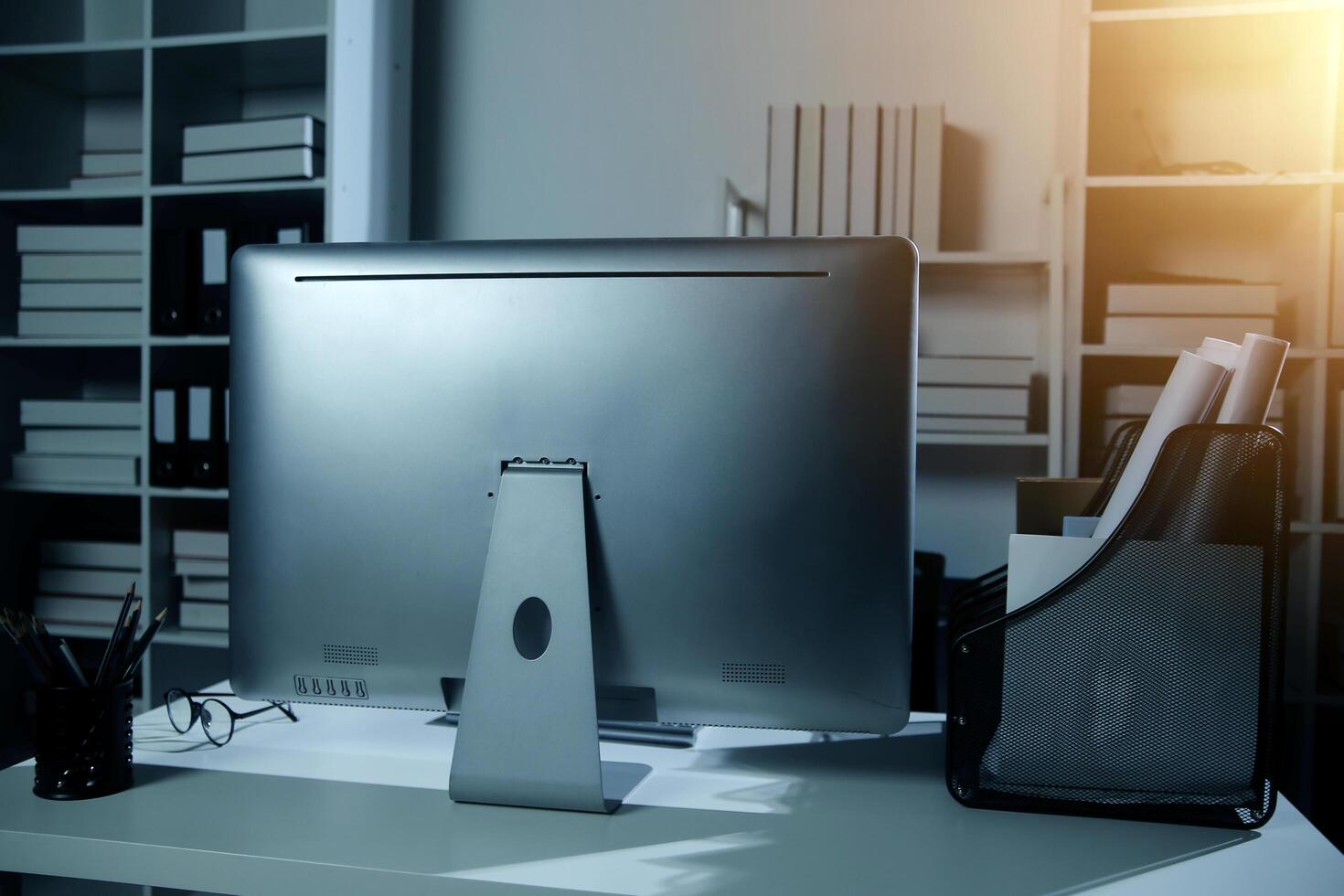 Laptop computer with opened lid on table in meeting room of office workspace. photo