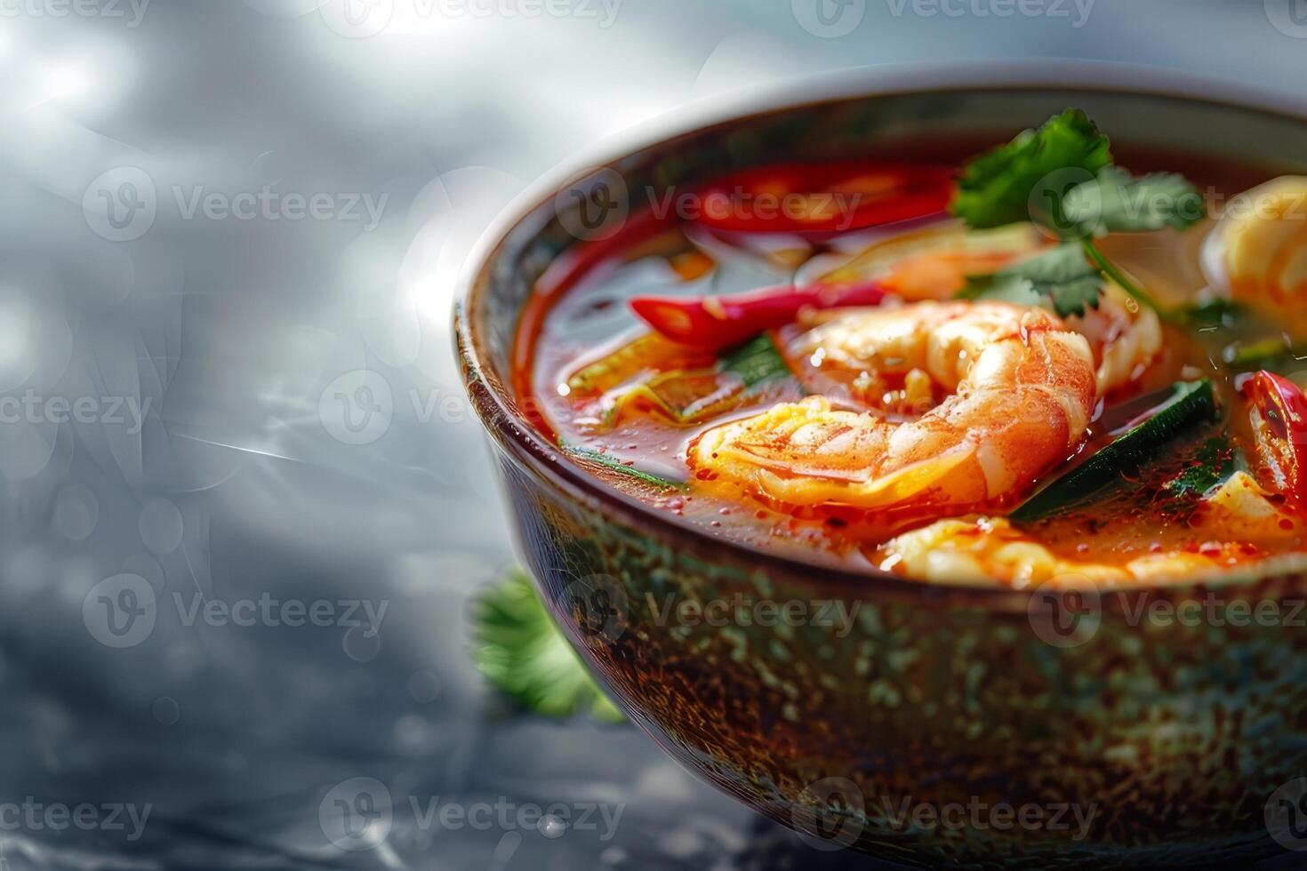 Tom yum soup with shrimps and basil in bowl, closeup. Thai food photo