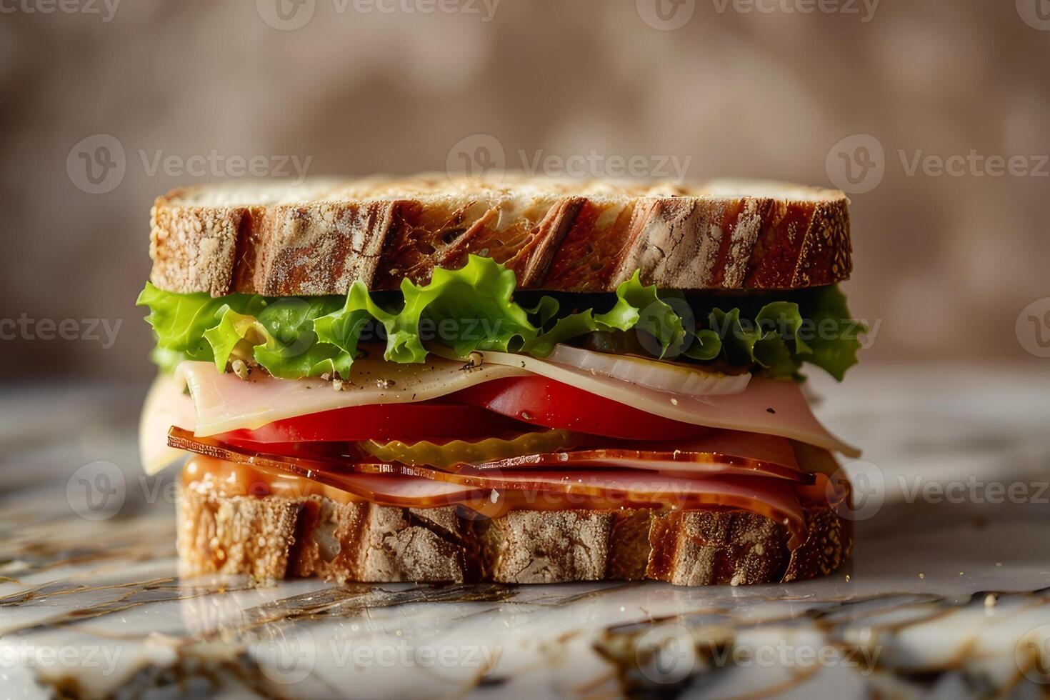 Sandwich with beef, cheese, tomato and lettuce on a marble background photo