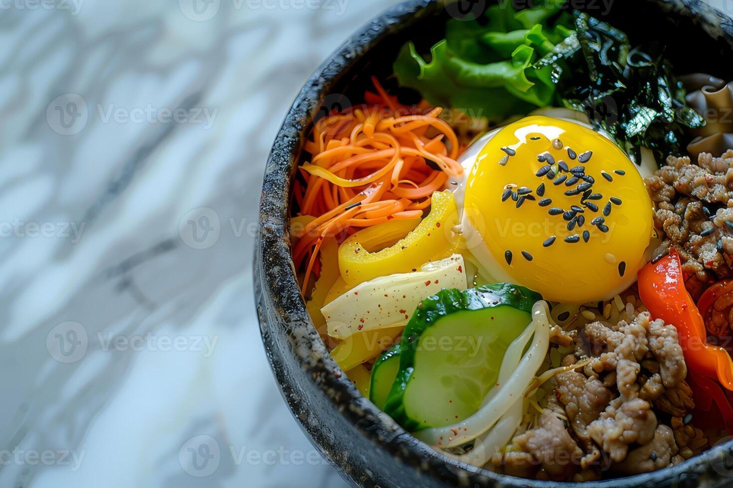 Bibimbap with rice, fried egg and vegetables in bowl photo
