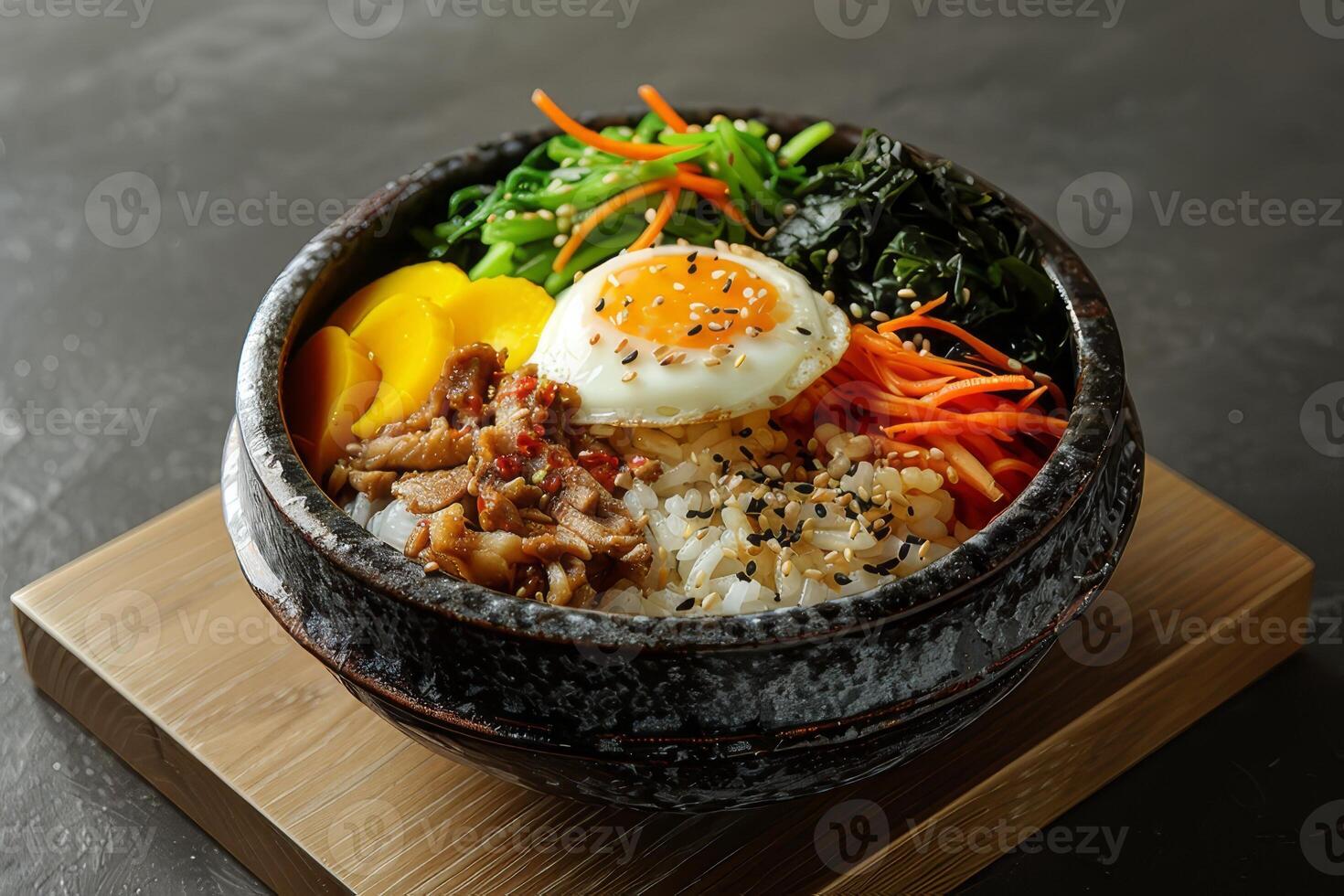 Bibimbap with rice, vegetables and egg in bowl photo