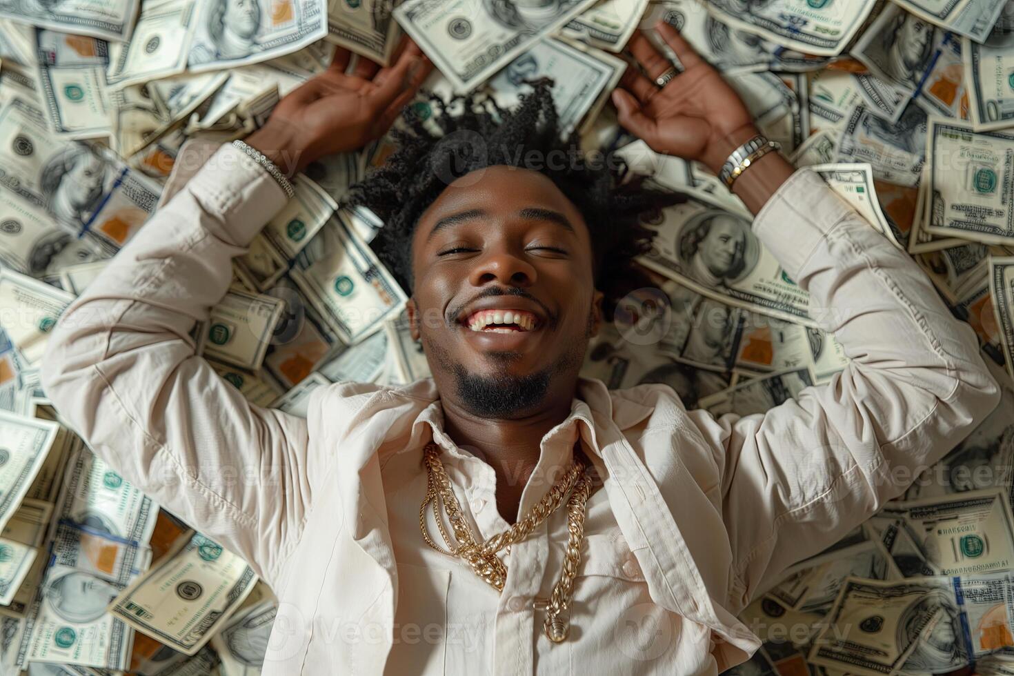 High angle view of young african american man with afro hairstyle smiling while lying on money photo