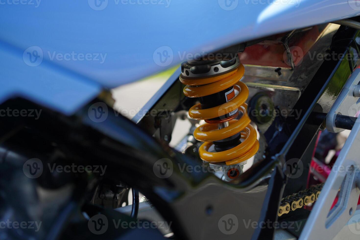 close up of monoshock spare parts from the 4-Stroke underbone motorbike category, yellow pear. photo