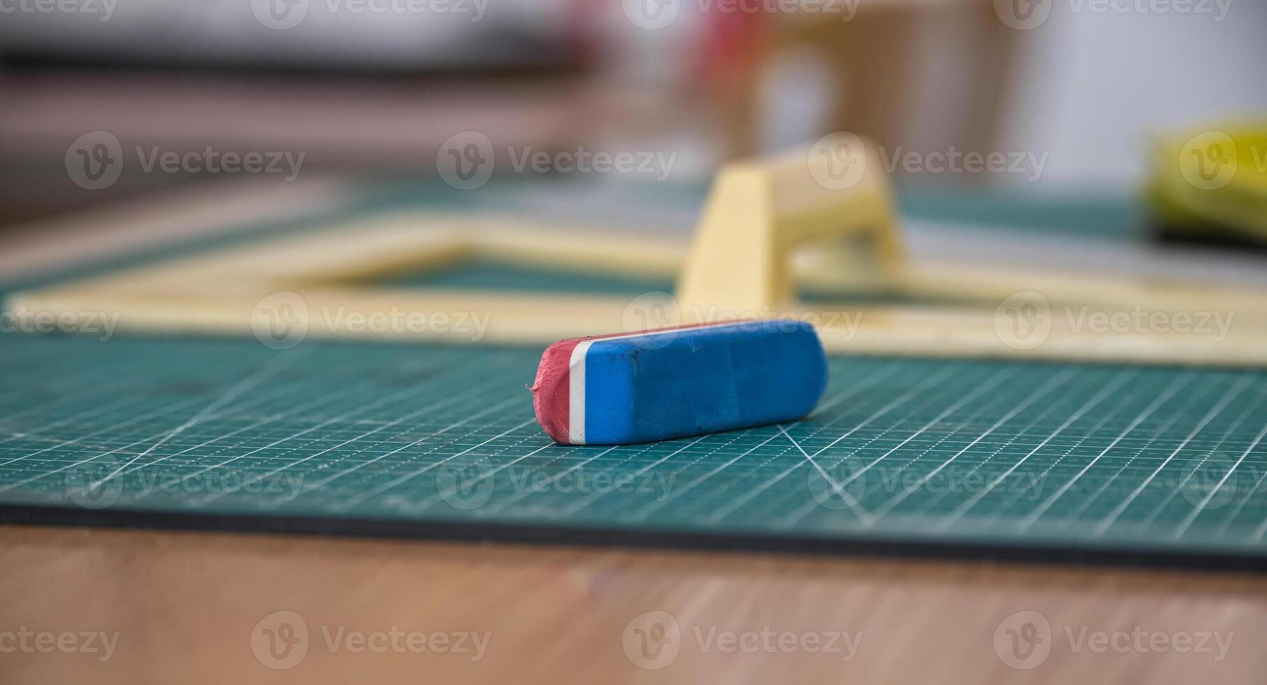 de cerca de un azul y rojo borrador en un verde corte estera en un Arte estudio foto