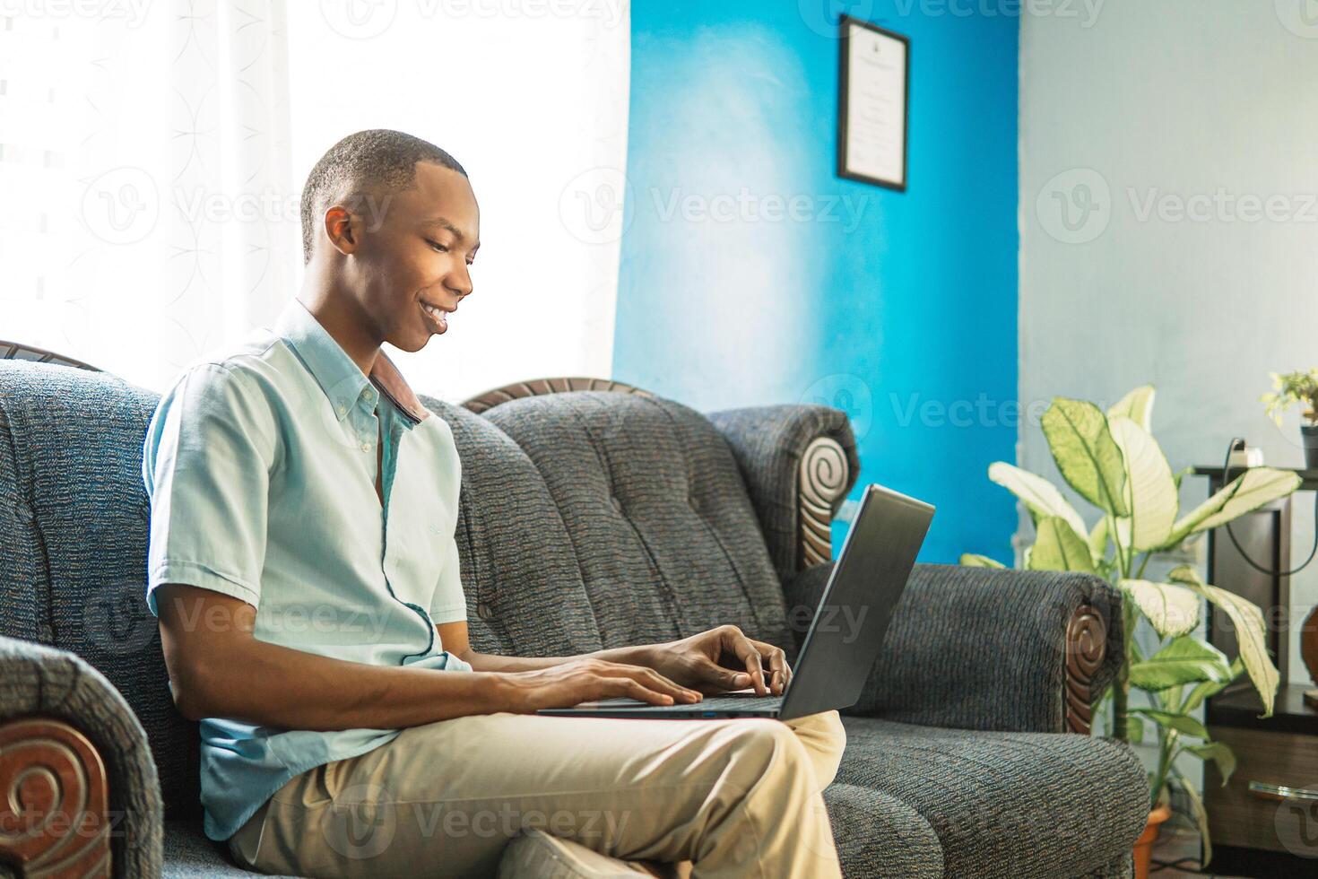 young man using a computer at home. photo