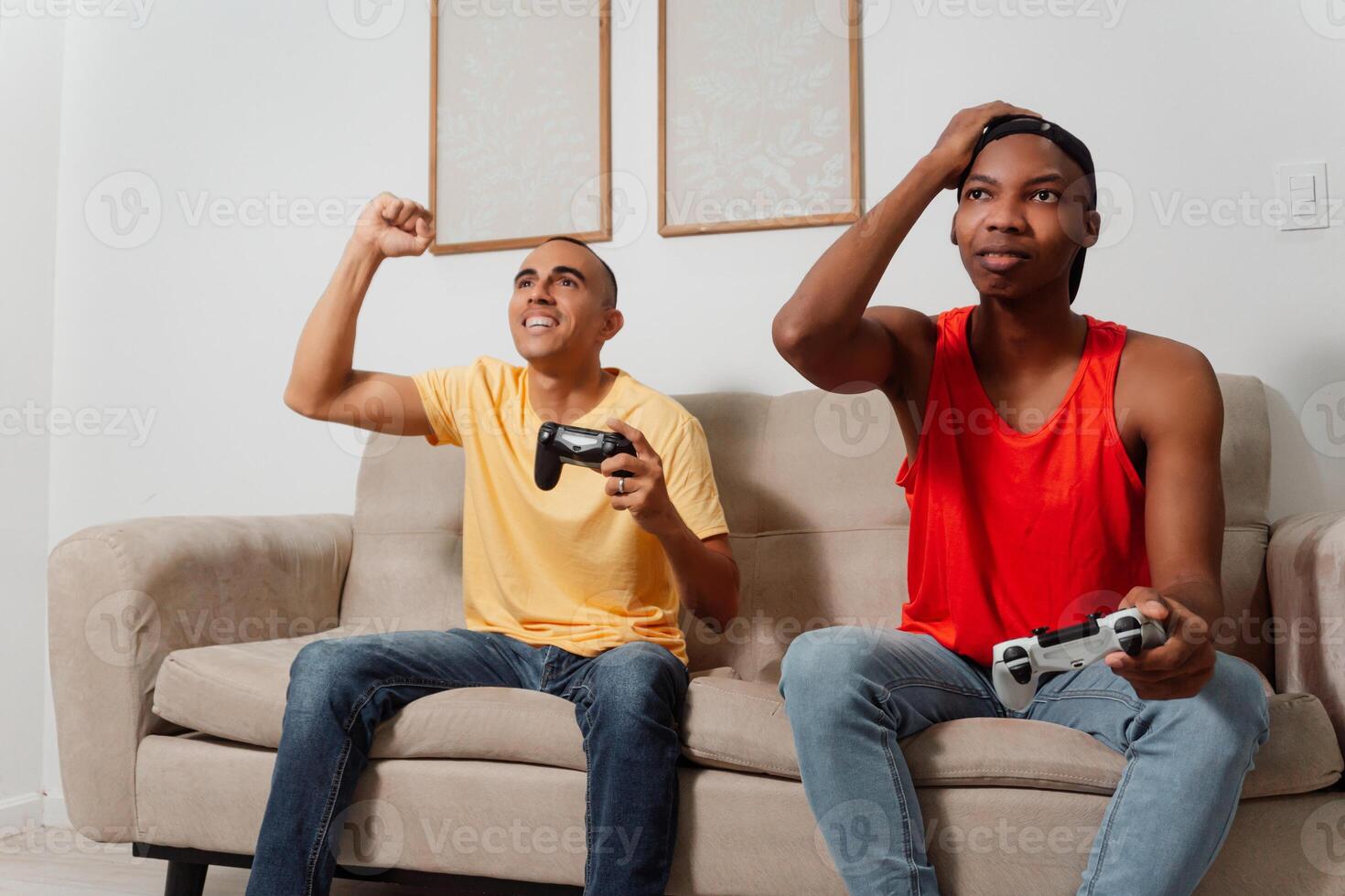 A couple of interracial friends playing games together at home. photo