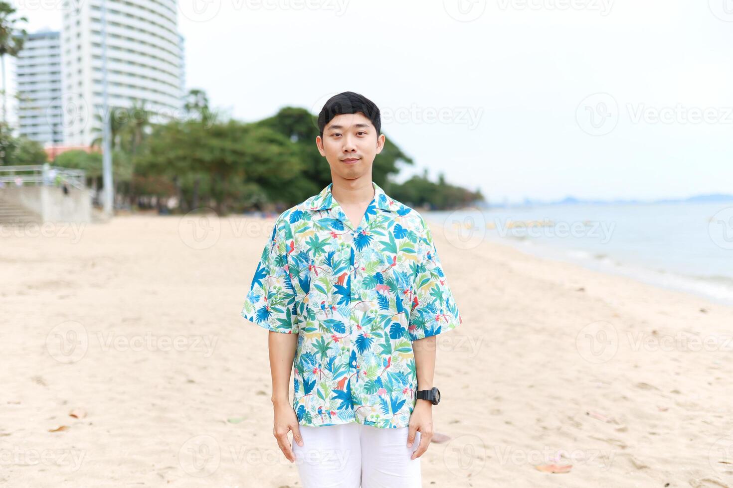 Portrait asian man tourism happy smiling on the beach with beautiful ocean background copy space photo