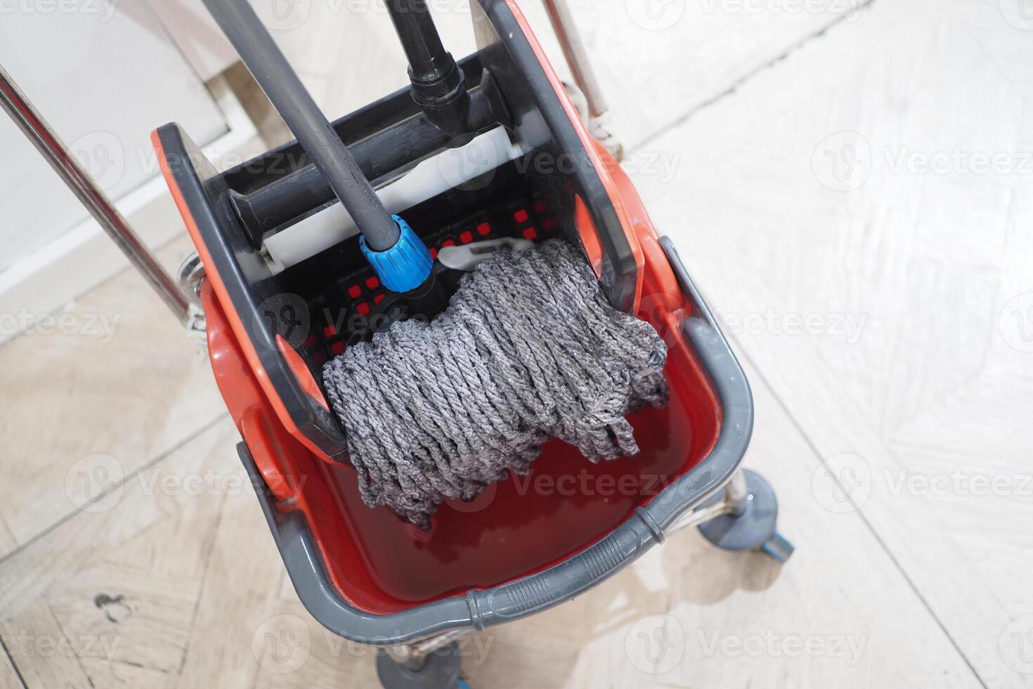 cleaning tiles floor with mop photo
