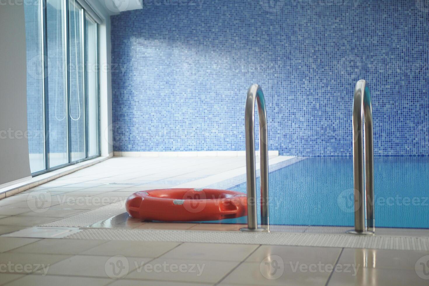 Red life buoy in swimming pool.. Help and support concept. photo