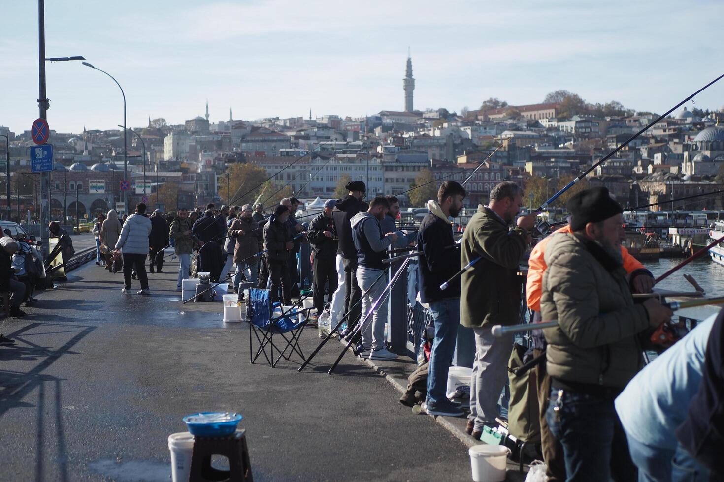 Turkey istanbul 12 january 2023. Fisherman with rod, spinning reel on bridge photo