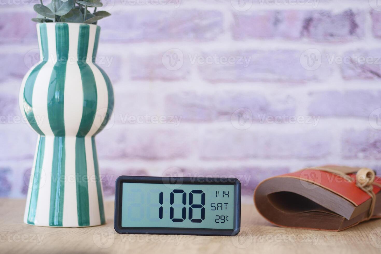 Start your day right by placing a digital alarm clock on a table to wake up in the morning photo