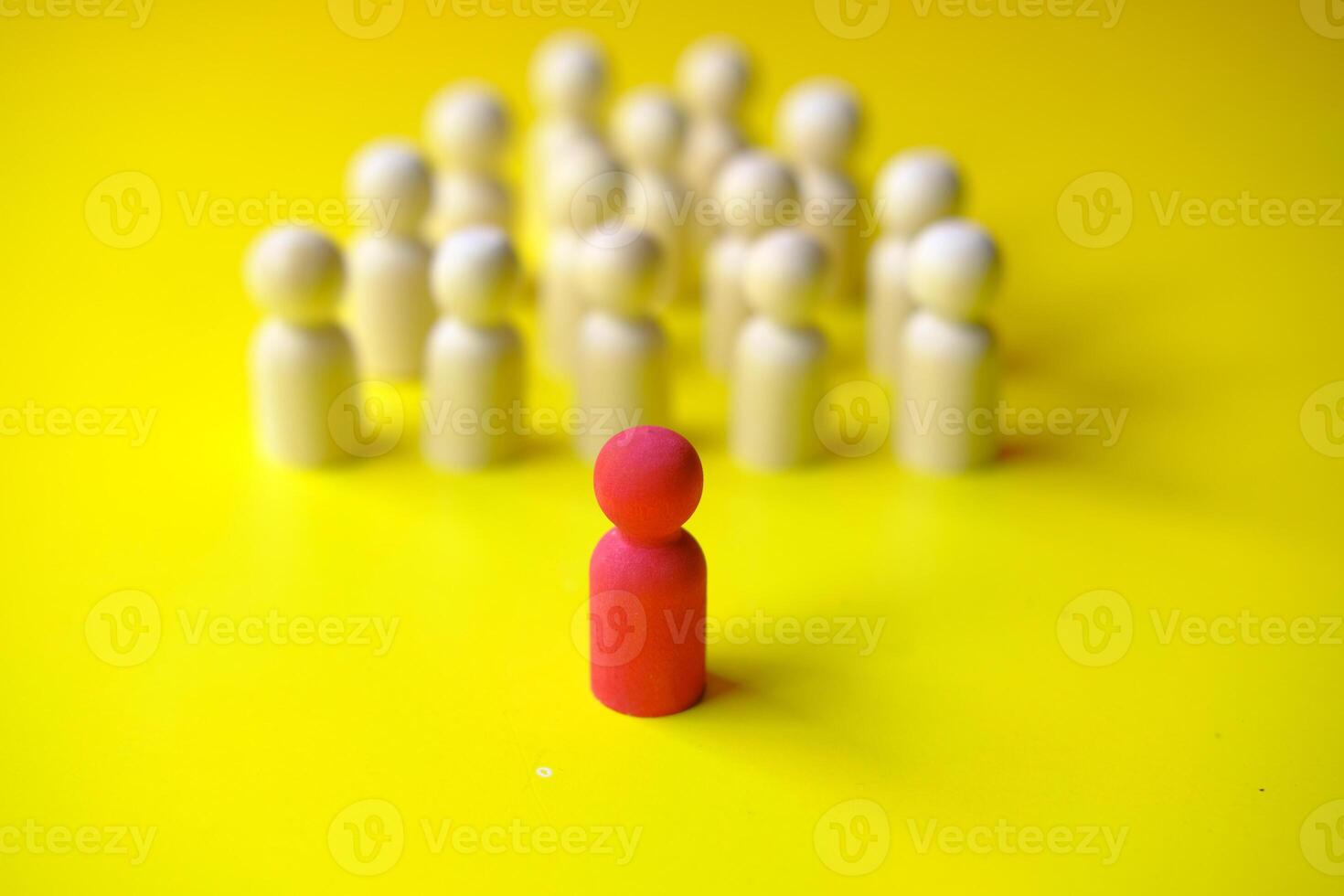 A stick wood block standing in front of a group of round wood block. photo