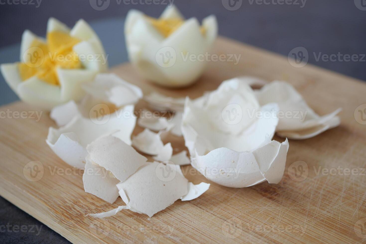 Broken egg shell on wooden cutting board, photo