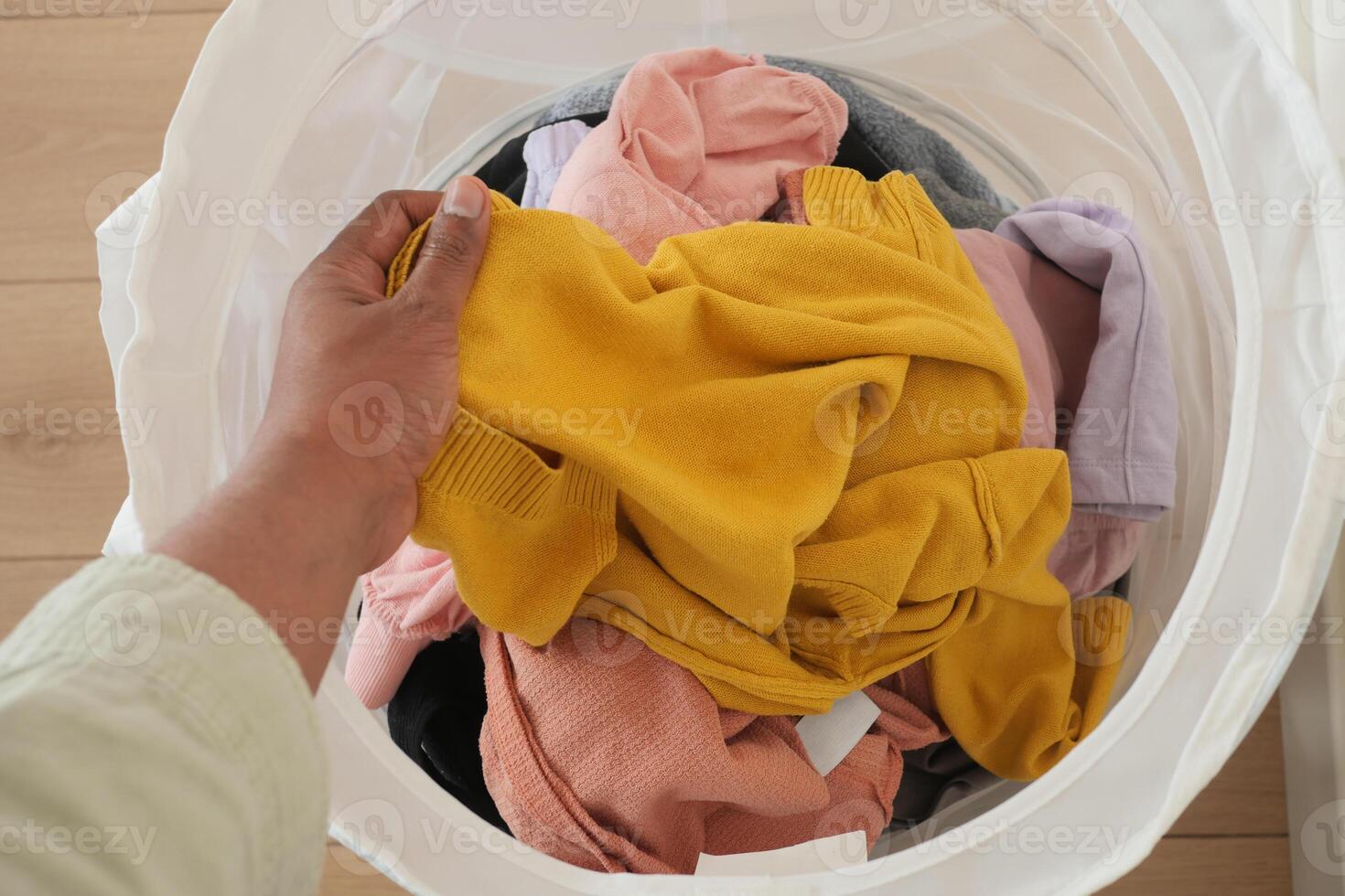 Old clothes thrown into the trash can. Disposal and recycling of clothes. photo