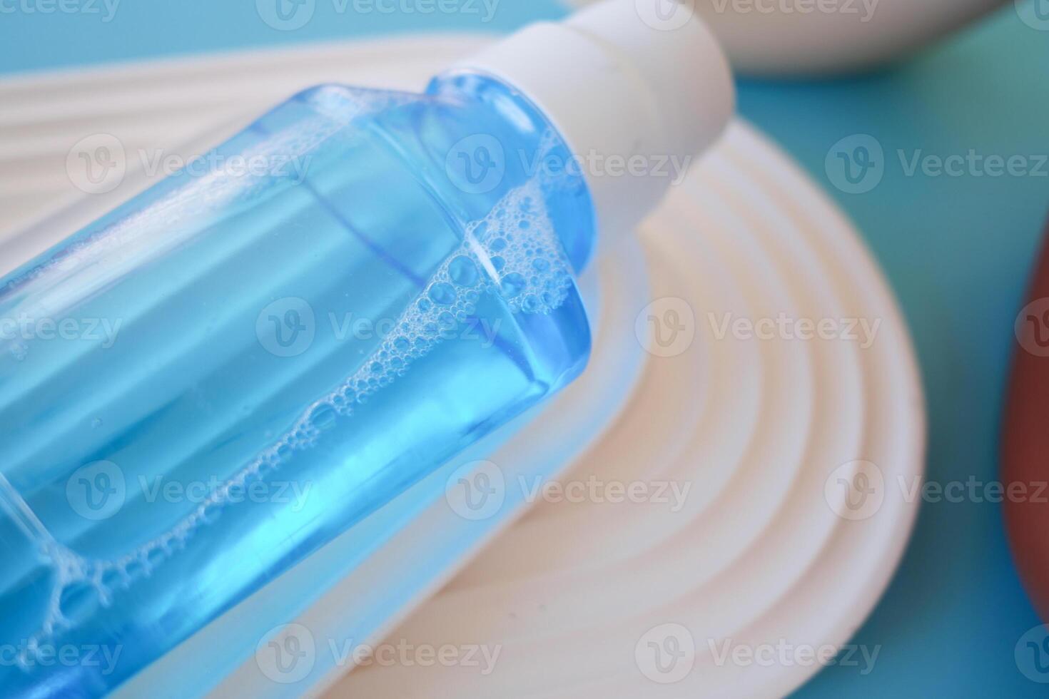 mouthwash liquid in a container on table photo